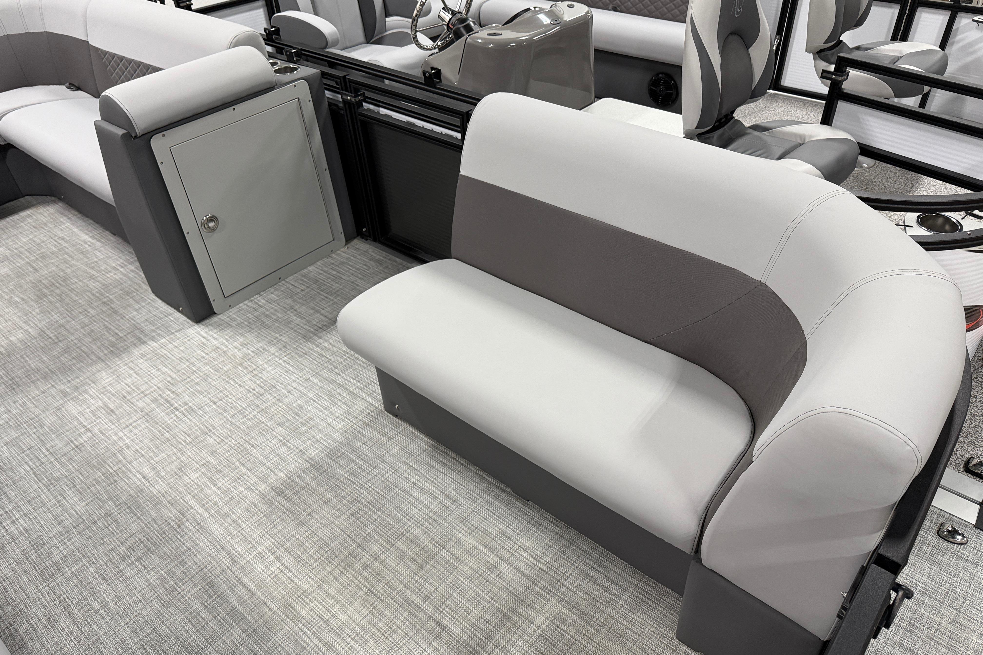 2026 Angler Quest 818 Panfish Cruise interior with gray seating and storage compartment.