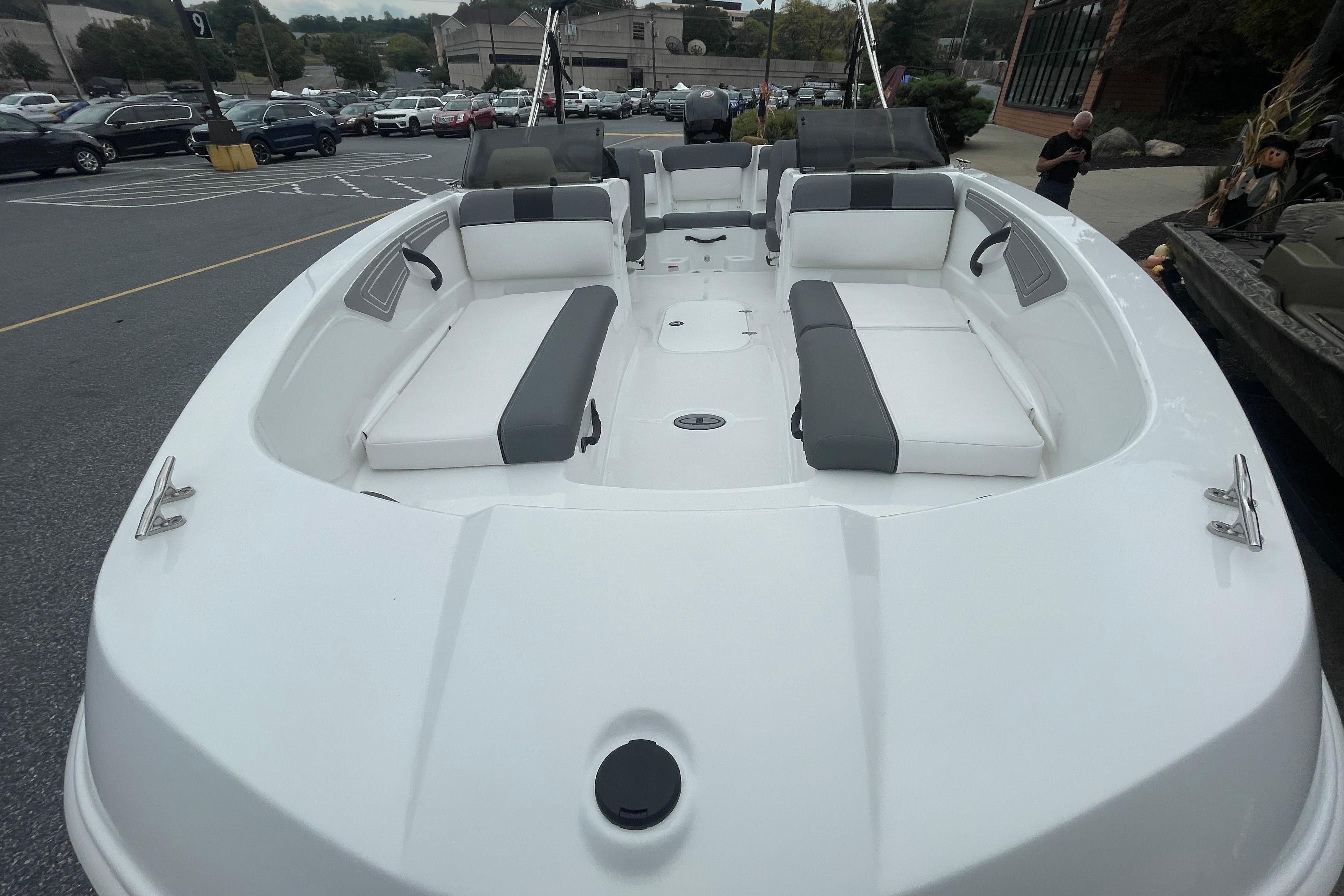 2026 Tahoe T21 boat with spacious seating, parked in a busy lot.