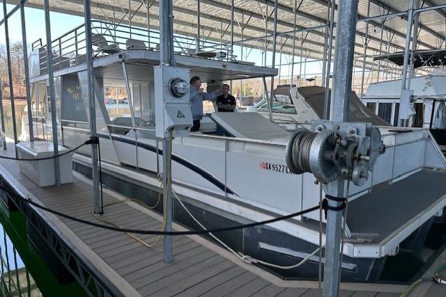 2008 Destination Yachts 45X14 houseboat docked under a covered marina.