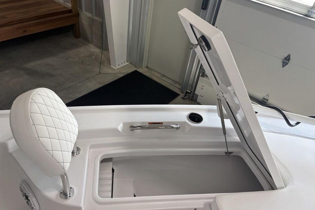 2026 Sportsman Masters 247 Bay Boat with open storage compartment and cushioned seat.