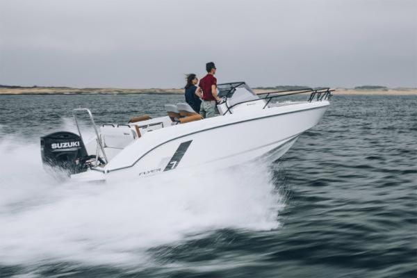 2025 Beneteau Flyer 7 SUNdeck speeding on water with two passengers.