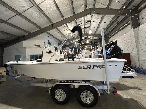 2025 Sea Pro 210 Bay boat on trailer in indoor showroom.