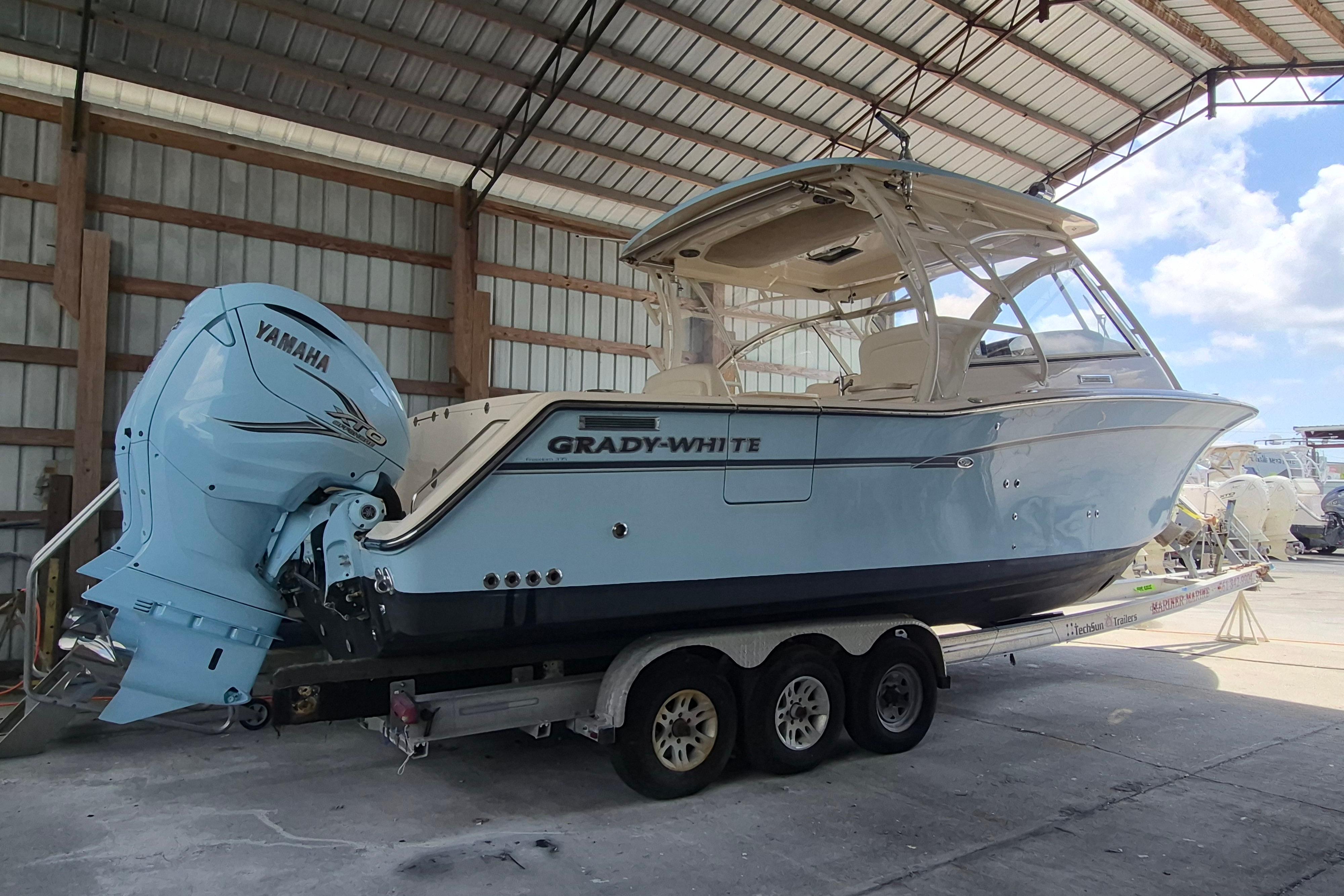 2019 Grady-White Freedom 335 boat with Yamaha engine on trailer in covered storage.