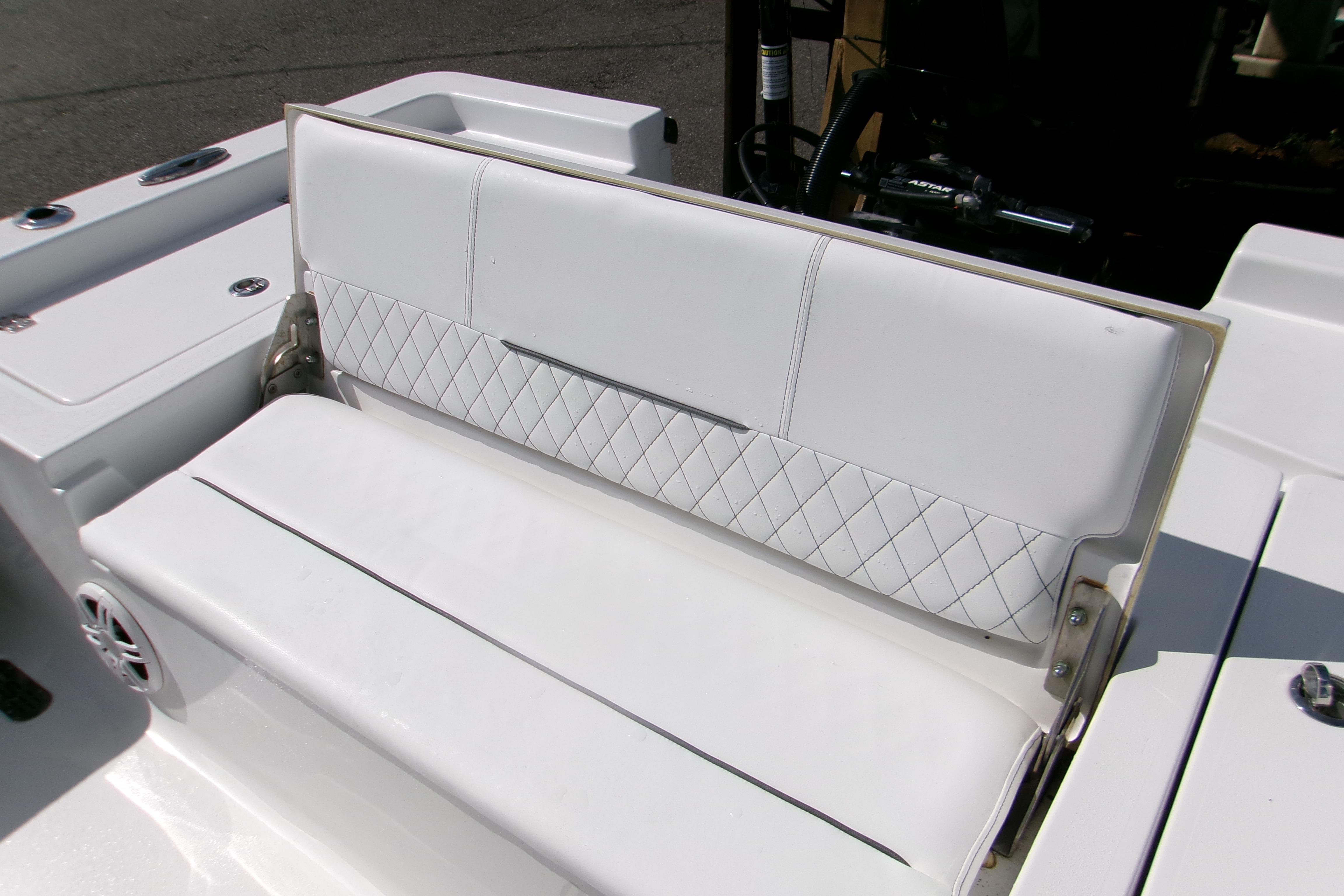 2024 Sportsman Masters 227 Bay Boat with white cushioned seating and diamond stitching.