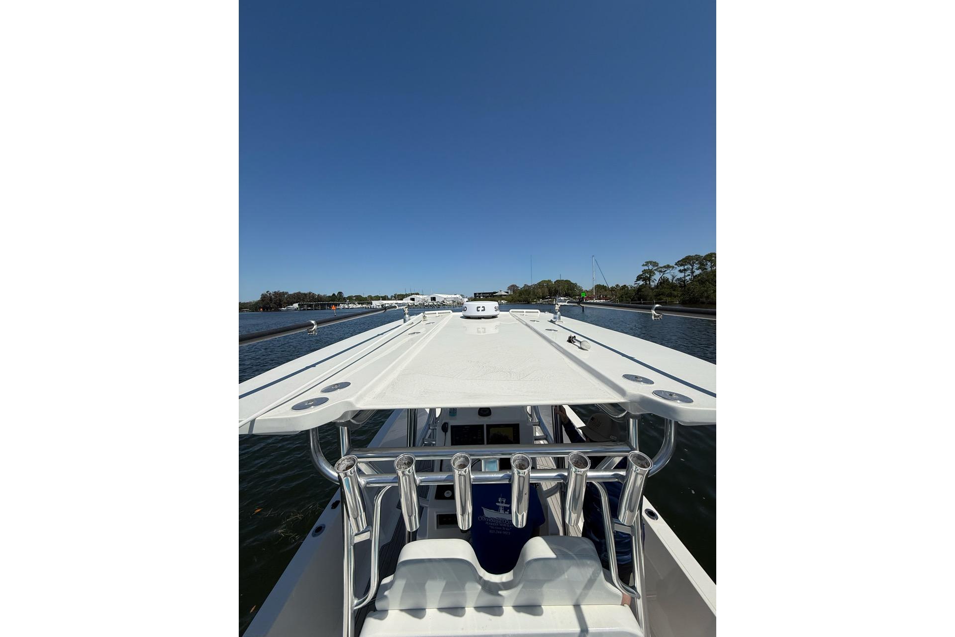 2021 Custom Infusion 34 CC boat on calm water under clear blue sky.