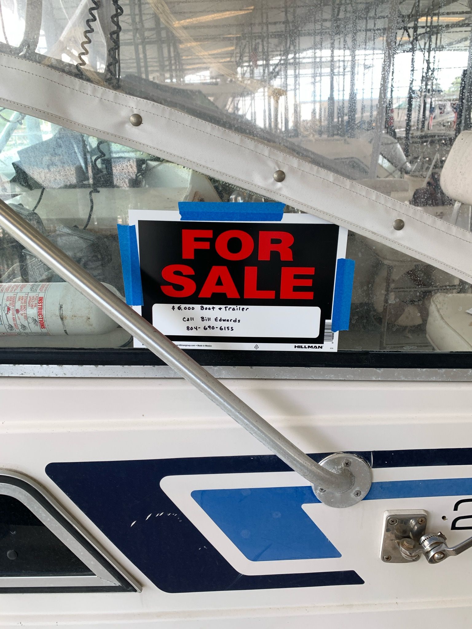 A 1987 Wellcraft Coastal is for sale. A sign is taped to a window.