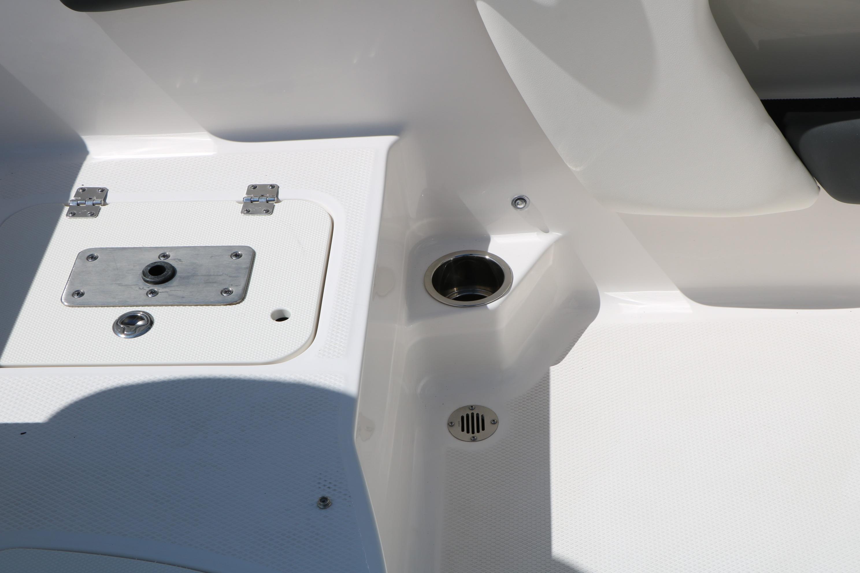 2025 Chaparral 21 SSi Ski & Fish boat interior detail, featuring storage and cup holder.