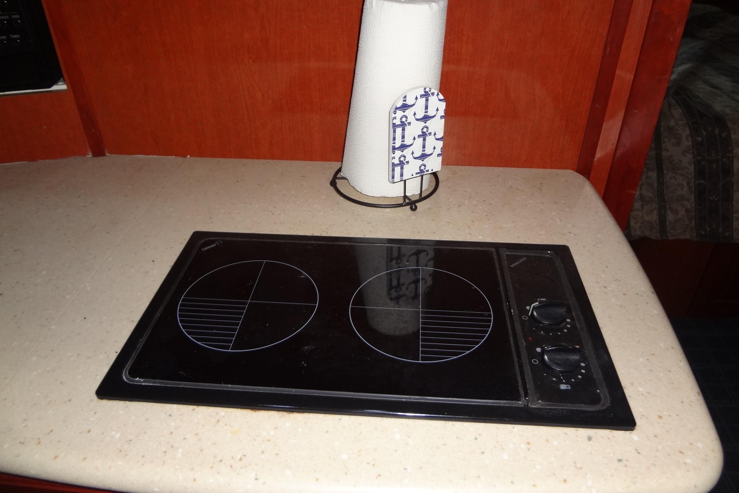 2008 Bluewater 5200 Signature Edition yacht kitchen with electric stovetop and paper towel holder.