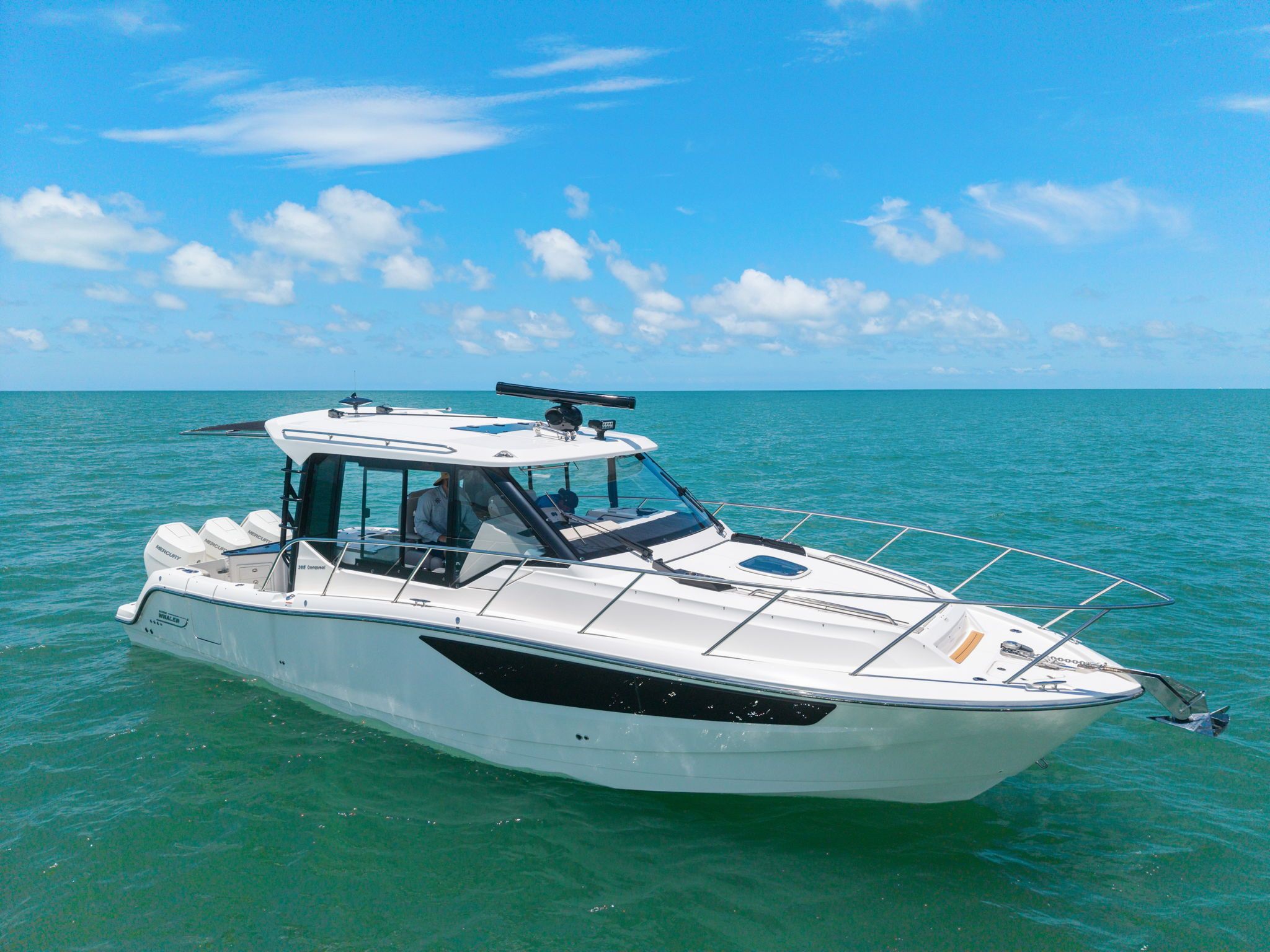 2025 Boston Whaler 365 Conquest on open sea under clear sky.