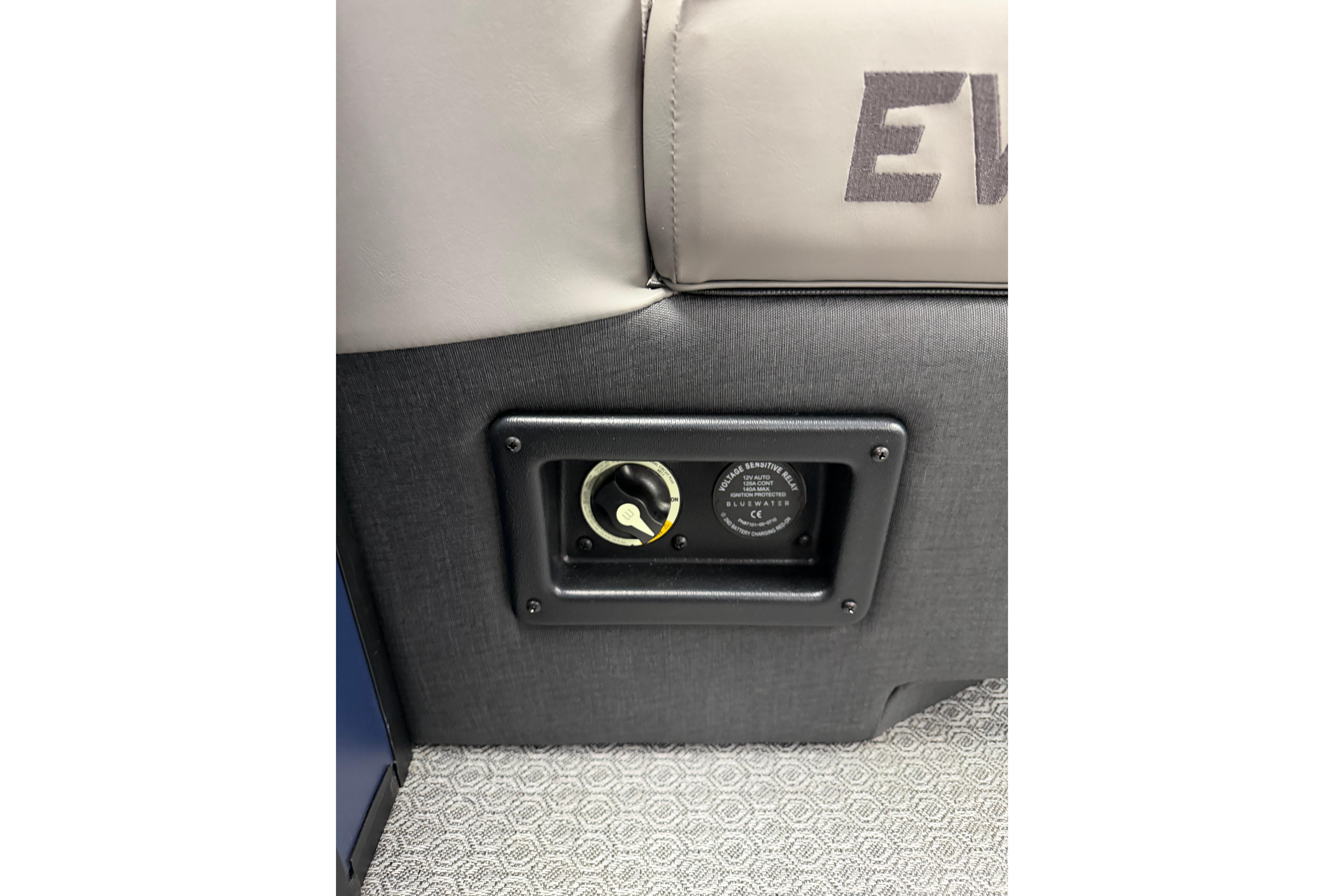 Power outlet on Evotti 523QL seat, 2026 model, with textured upholstery.