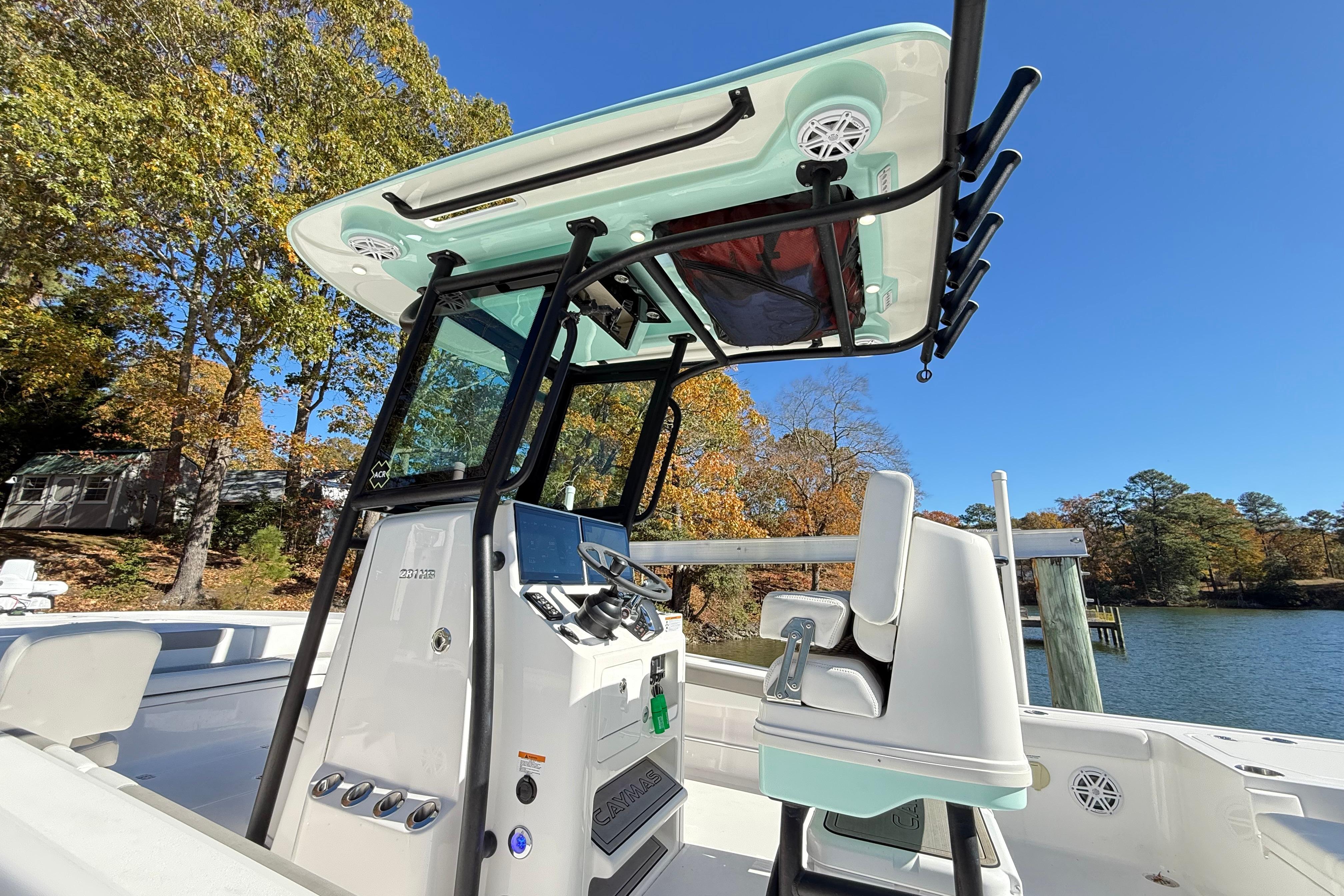 2023 Caymas 281 HB boat with advanced console and seating, set against a scenic lake backdrop.