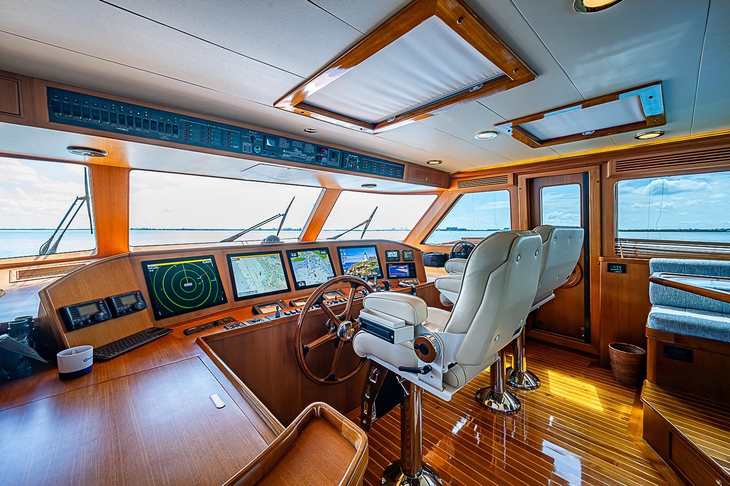 Luxurious helm of 2014 Marlow 80 Explorer yacht with advanced navigation systems.