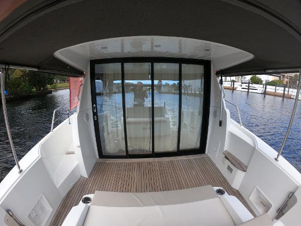 2017 Jeanneau NC 11 boat with spacious deck and sliding glass doors.