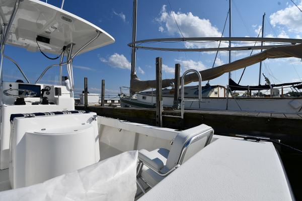 2021 Eastern 248 Center Console boat docked at a marina on a sunny day.