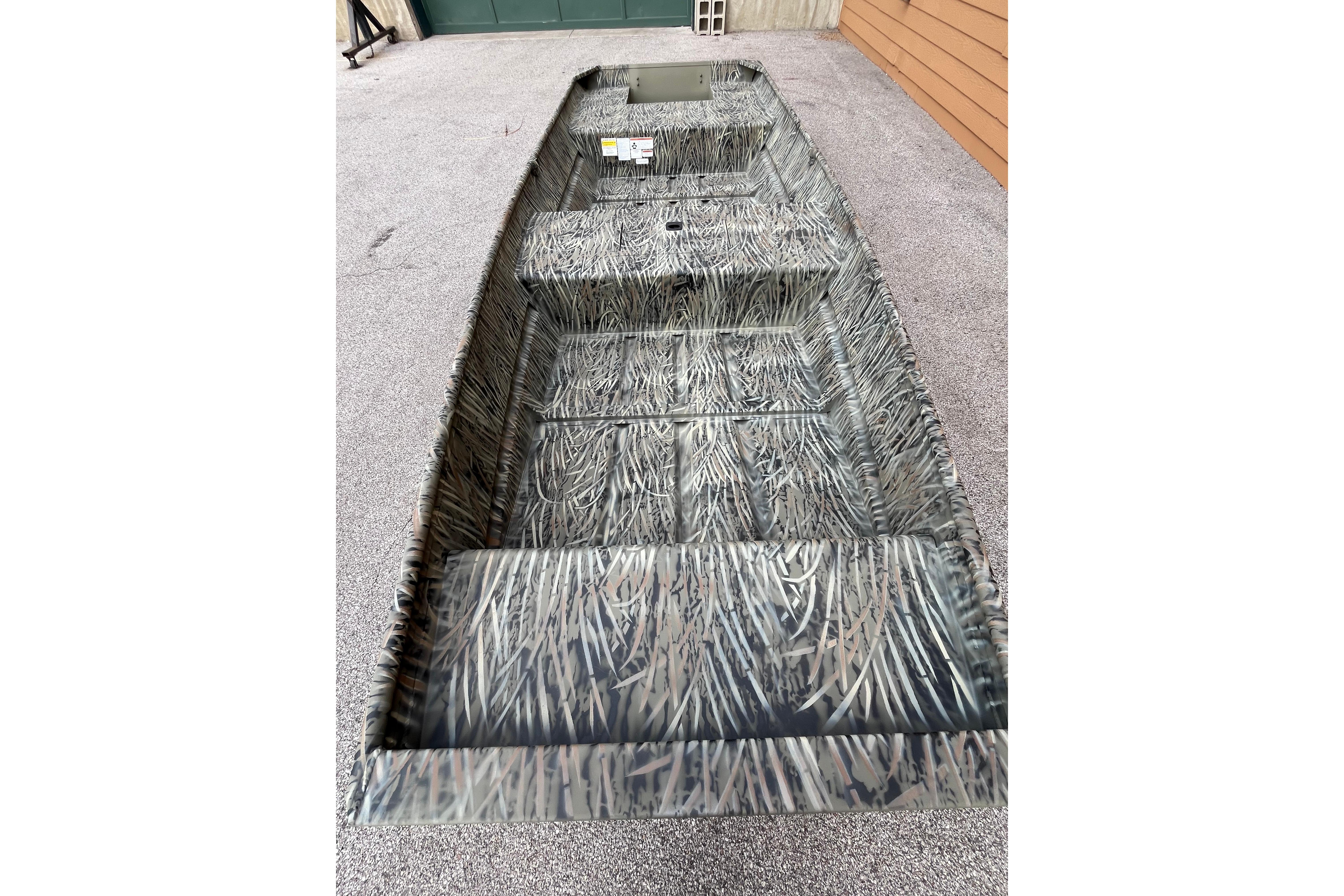 2026 Tracker Grizzly 15 Jon boat with camouflage design on display.