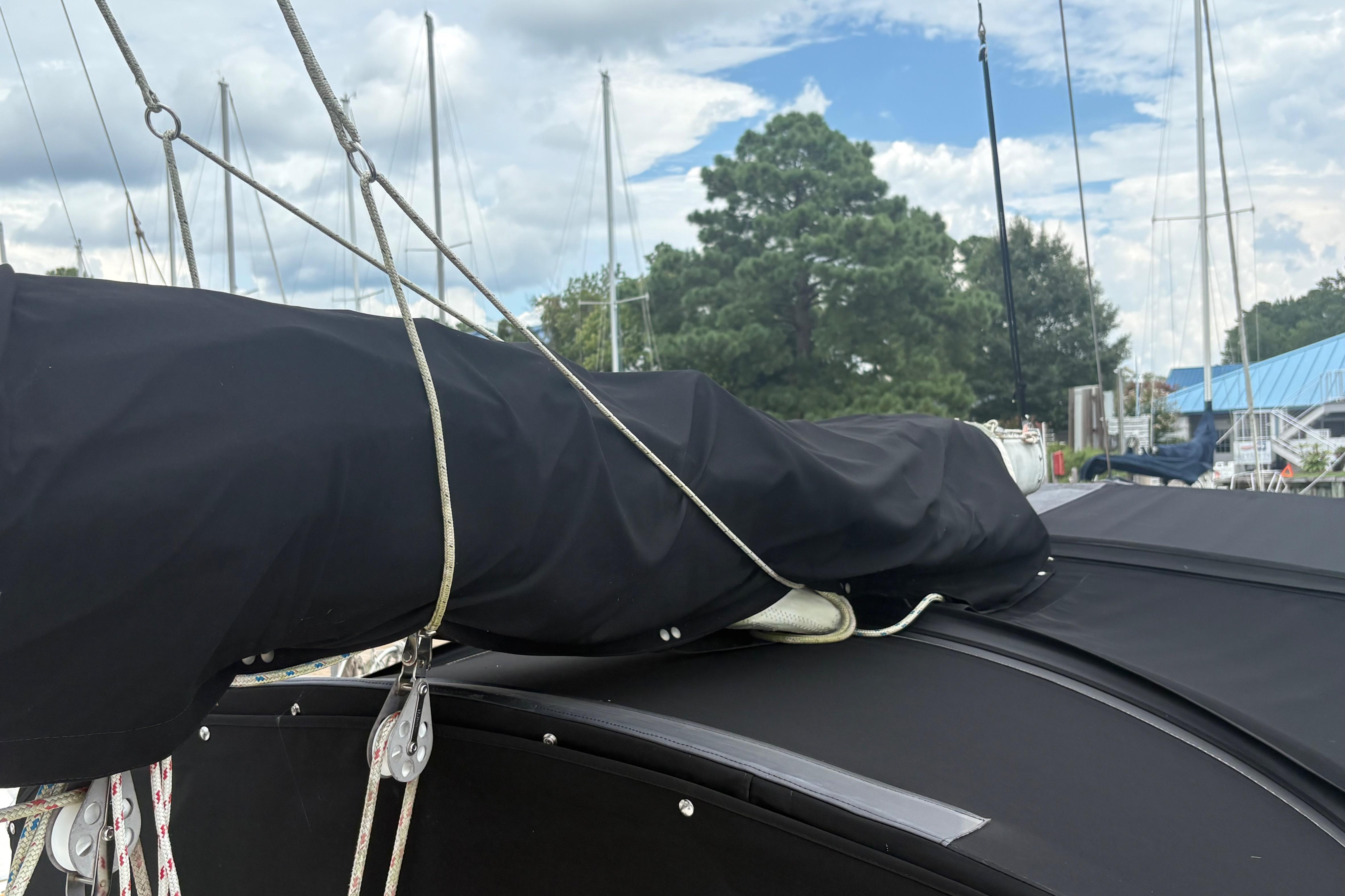 1981 Sabre 31 sailboat with covered boom and rigging in marina setting.