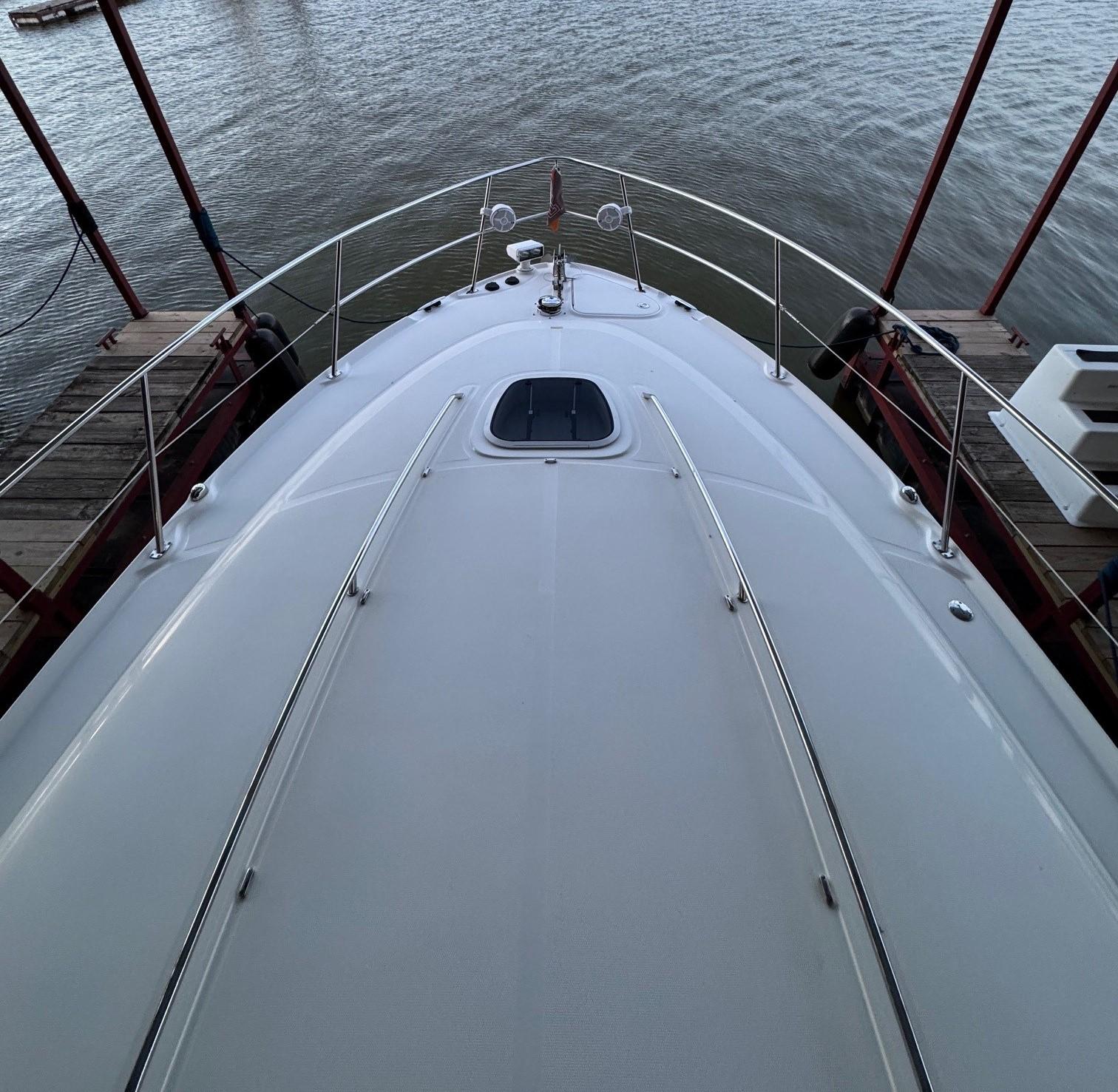 2007 Sea Ray 38 Sundancer yacht bow view at dock, overlooking calm water.
