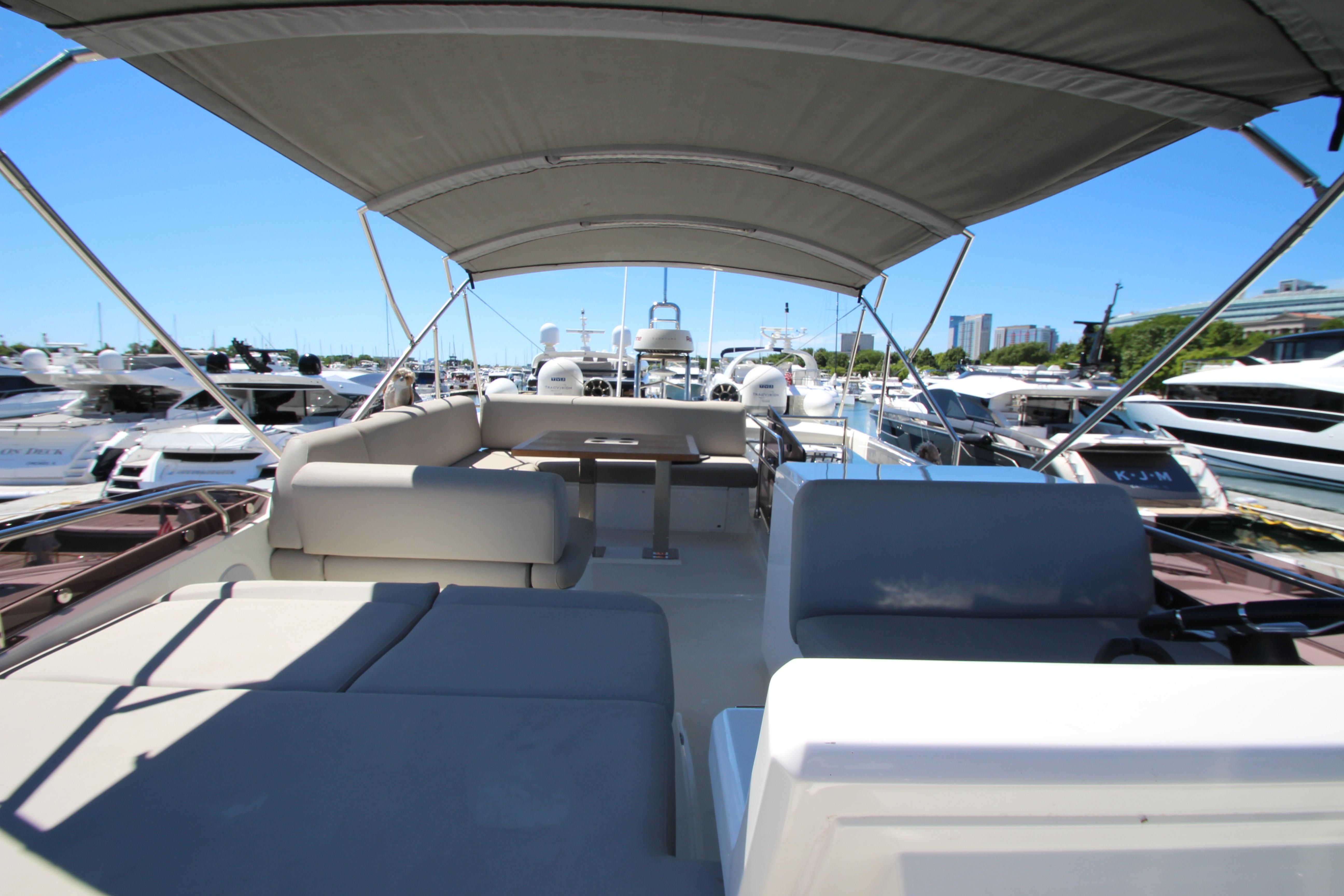 Luxurious 2022 Prestige 520 yacht interior with canopy, docked at marina.