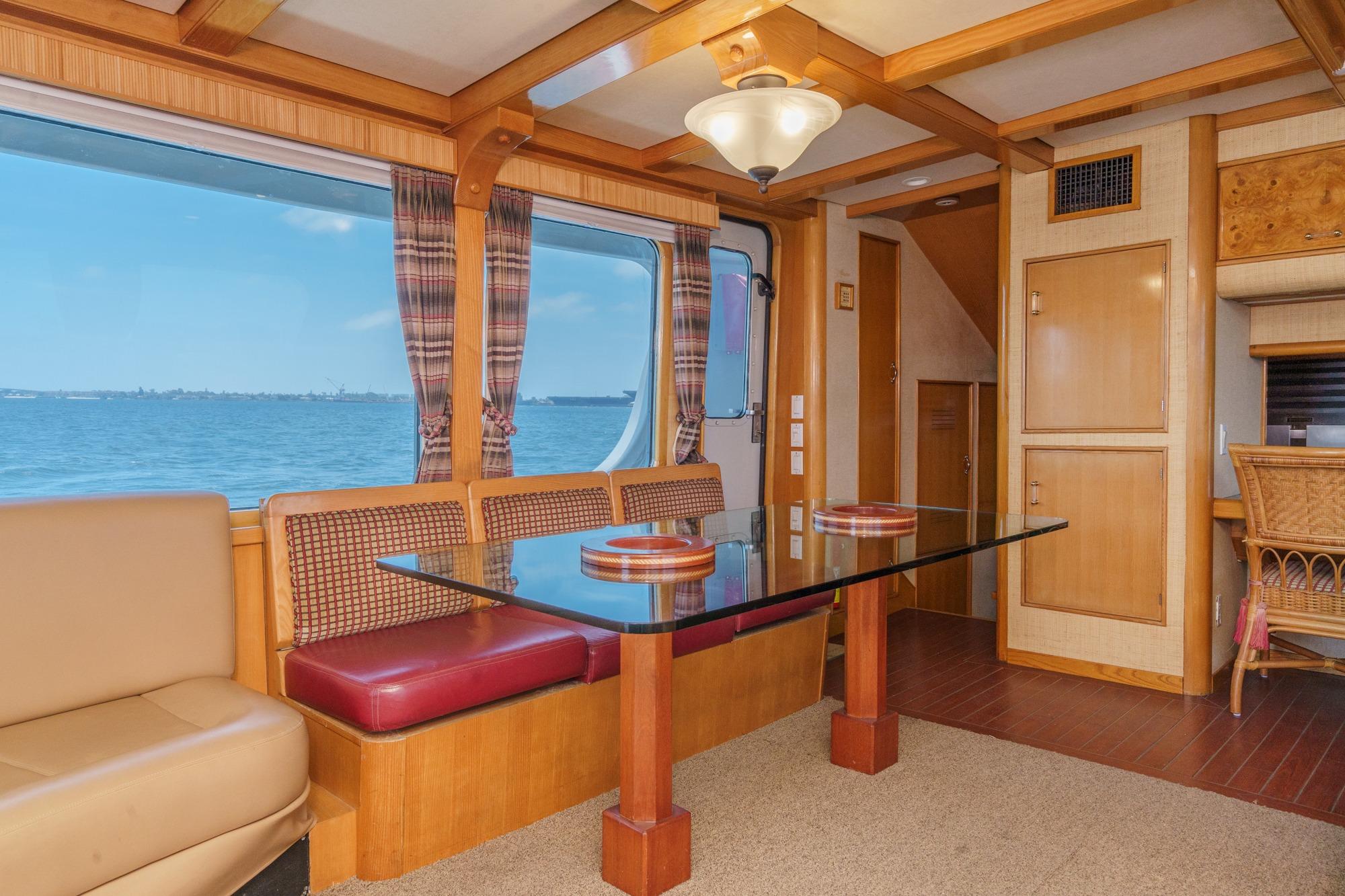 Interior of a 1990 Seaton Long Range Cruiser with dining area and ocean view.