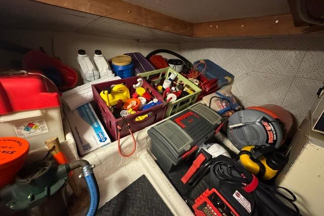Storage area on a 1986 Kadey-Krogen 42 boat with tools and supplies.