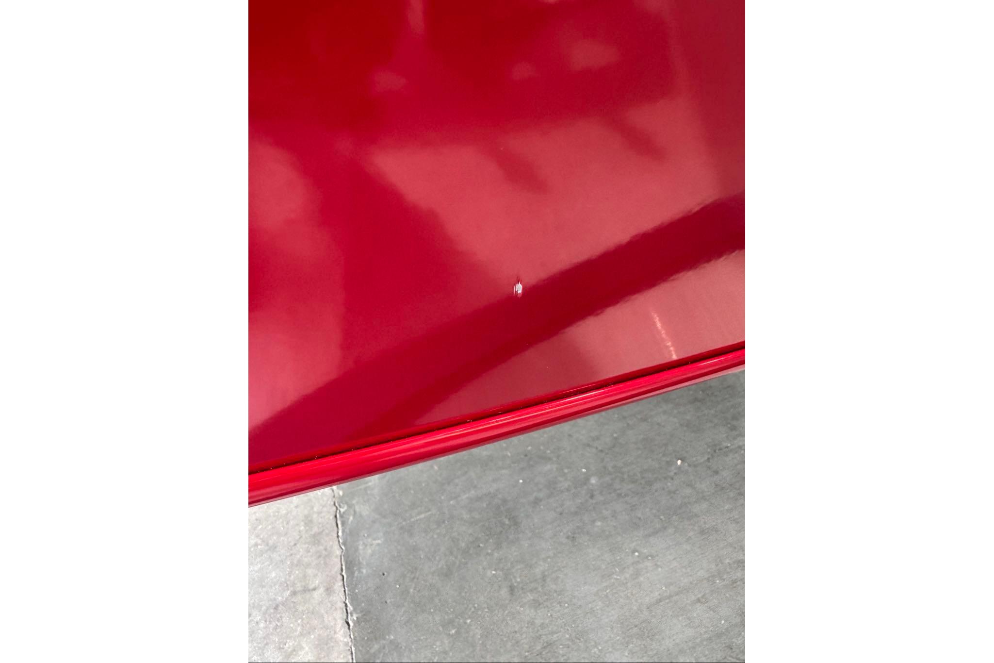 Close-up of a red 2026 Tracker Bass Tracker Classic XL boat surface.