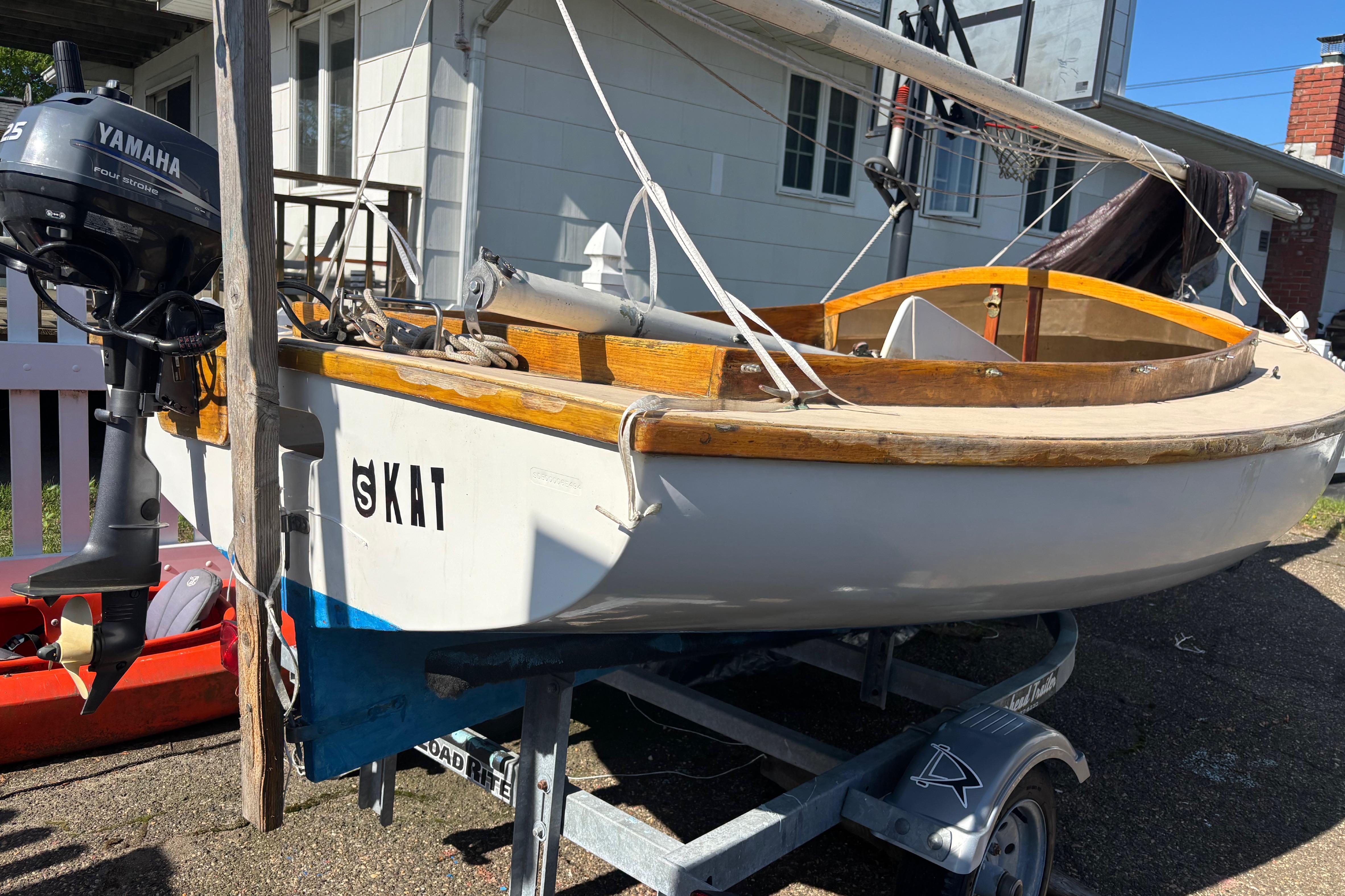 1994 STUR D CAT sailboat on trailer with Yamaha outboard motor.