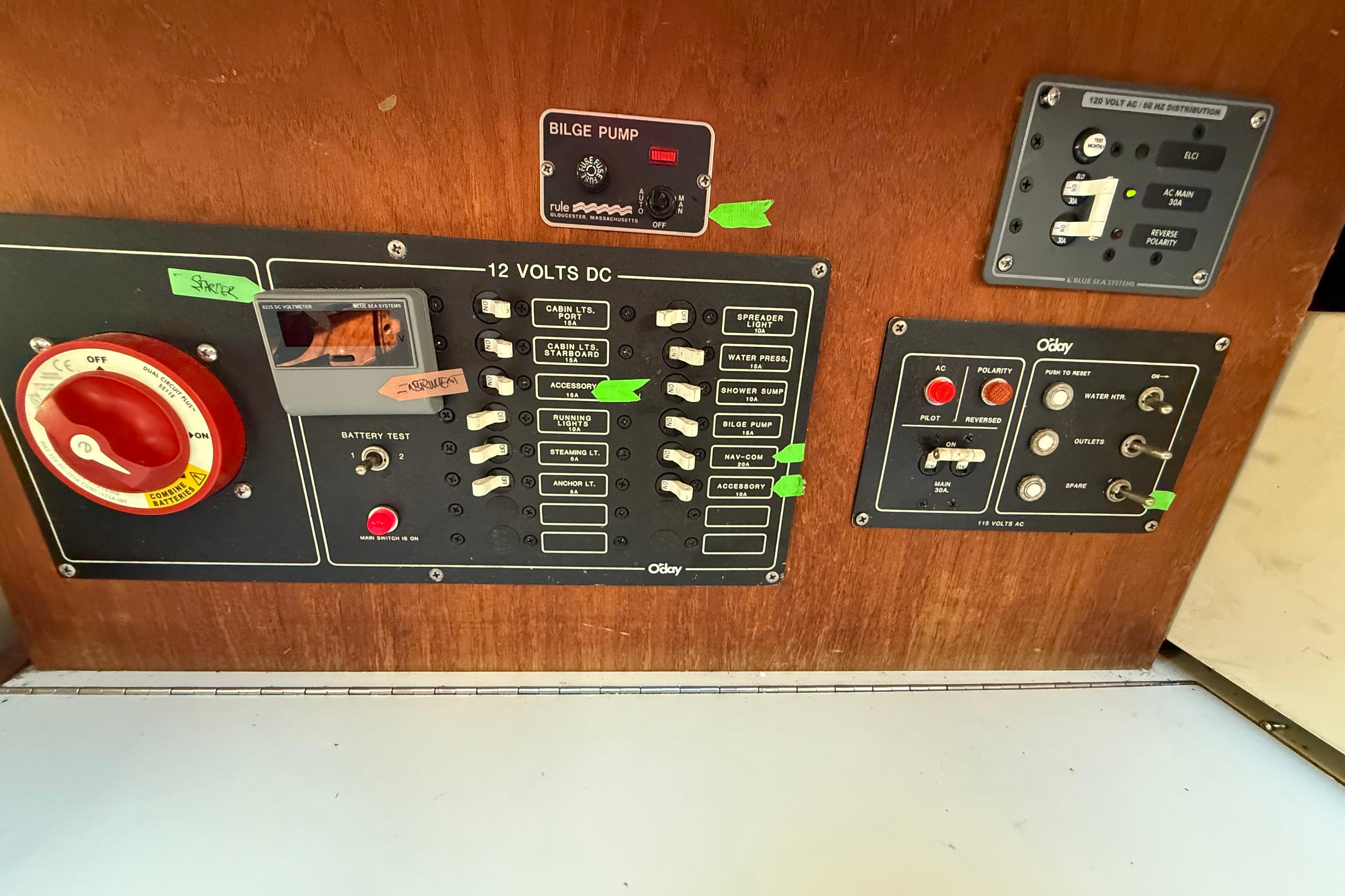 Electrical control panel of a 1983 O'Day 34 sailboat with various switches and indicators.