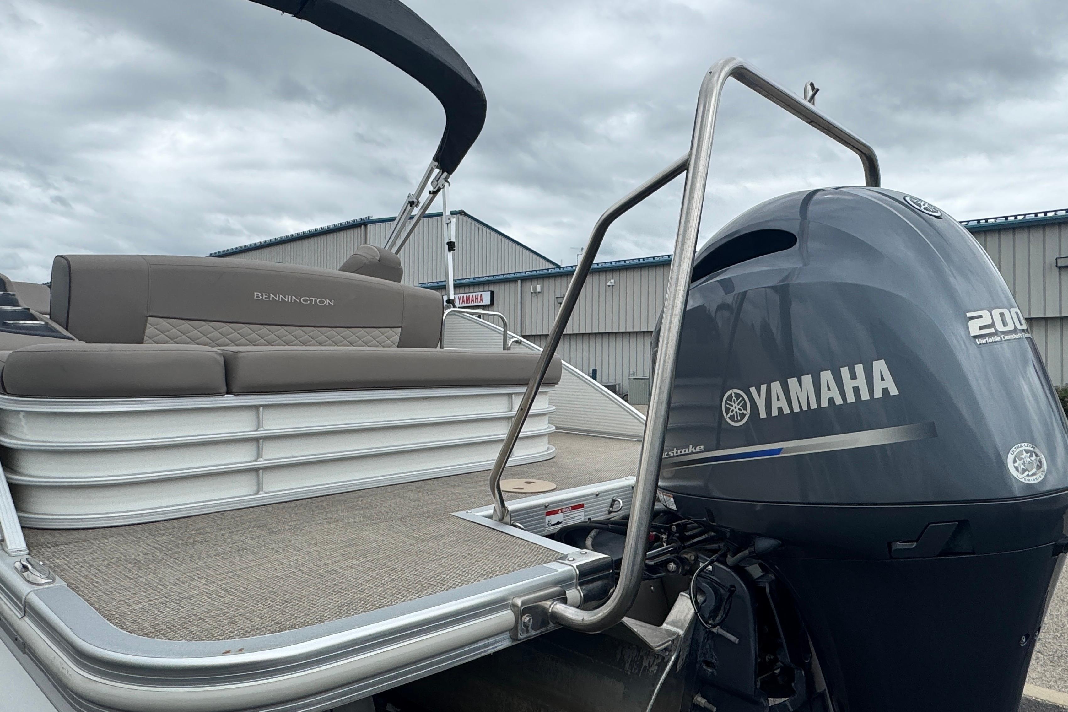 2019 Bennington SX 22 SSBXP pontoon boat with Yamaha 200 engine, docked under cloudy skies.