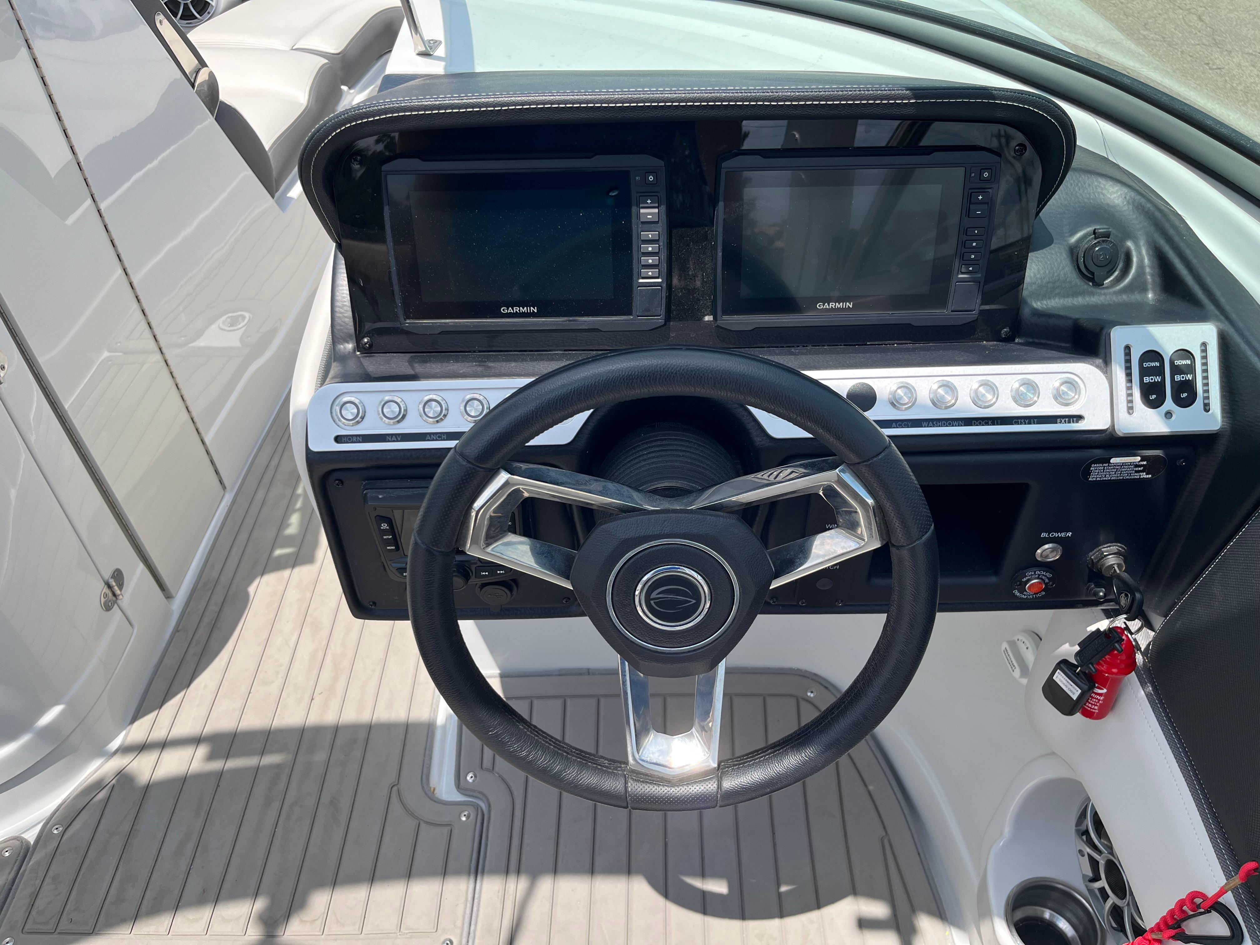 2022 Crownline 280 SS boat dashboard with steering wheel and dual Garmin displays.