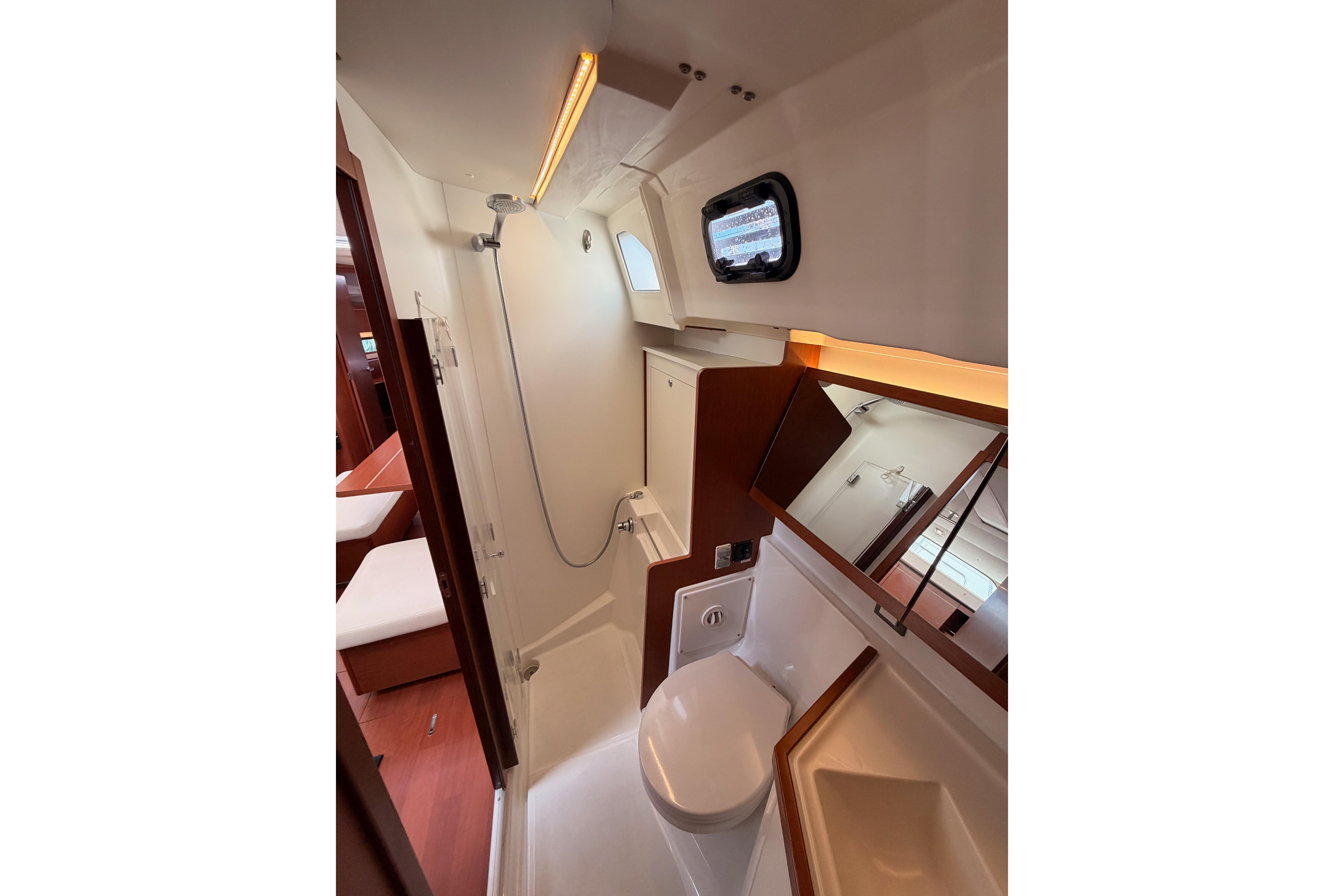 Modern bathroom interior of 2020 Beneteau Oceanis 46.1 yacht, featuring shower and toilet.