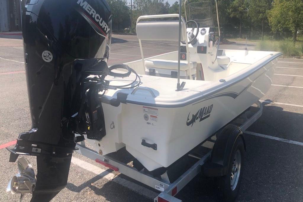 2026 Mako Pro Skiff 17 CC boat with Mercury outboard motor in parking lot.