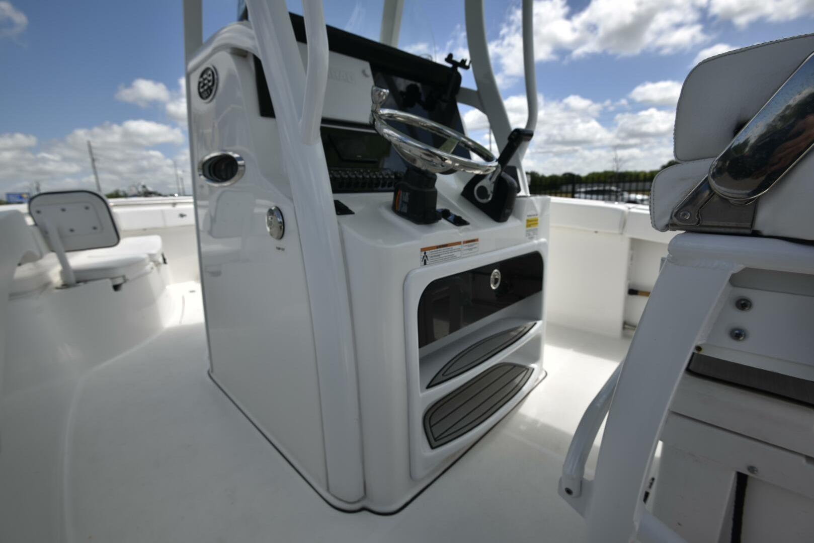 2023 Sea Pro 239 Deep V CC boat interior with steering console and seating.