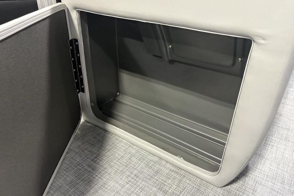 2026 Sun Tracker PARTY BARGE® 20 DLX storage compartment with open door, gray interior.