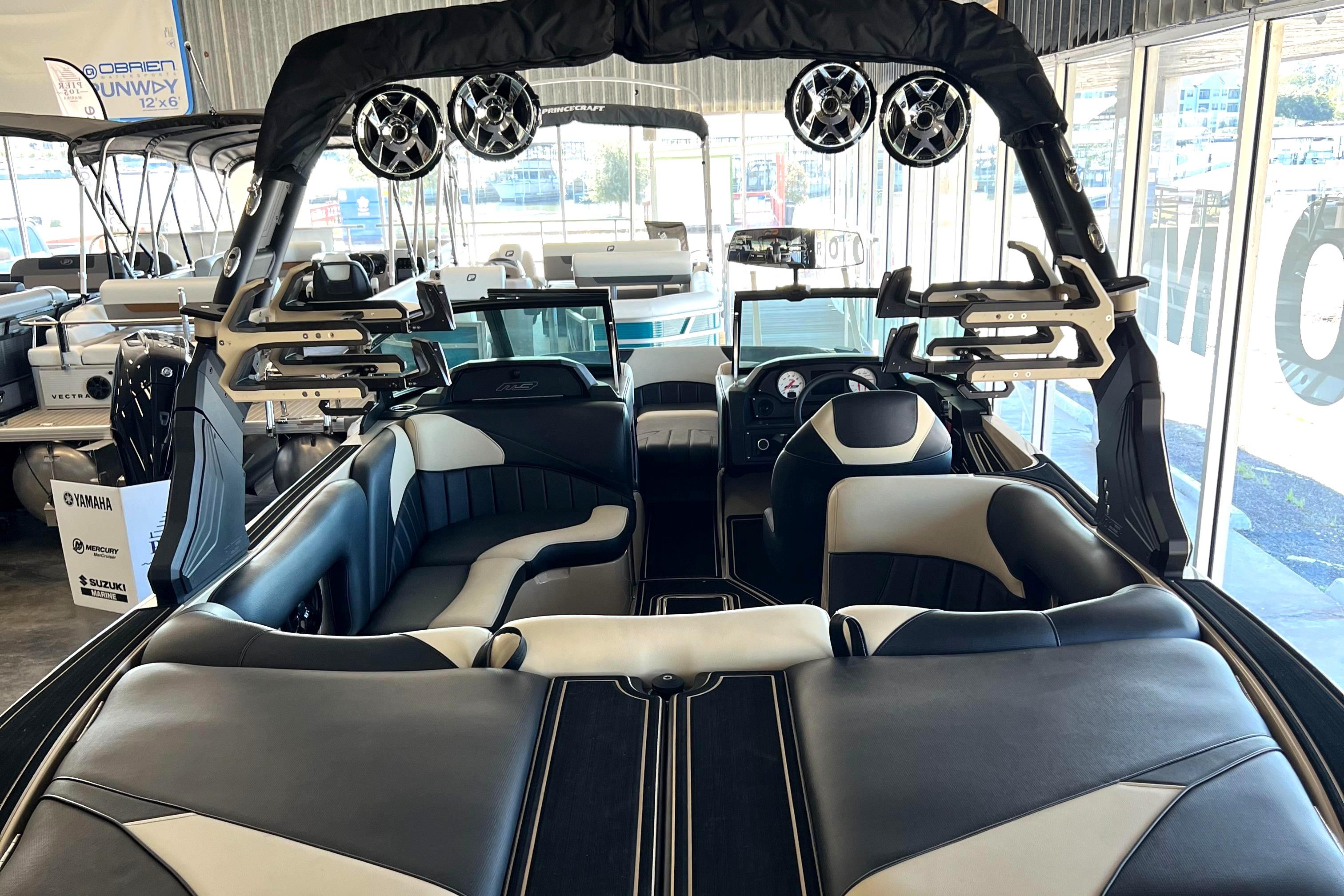 2024 MB F22 Tomcat boat interior with black and white seating and advanced audio system.