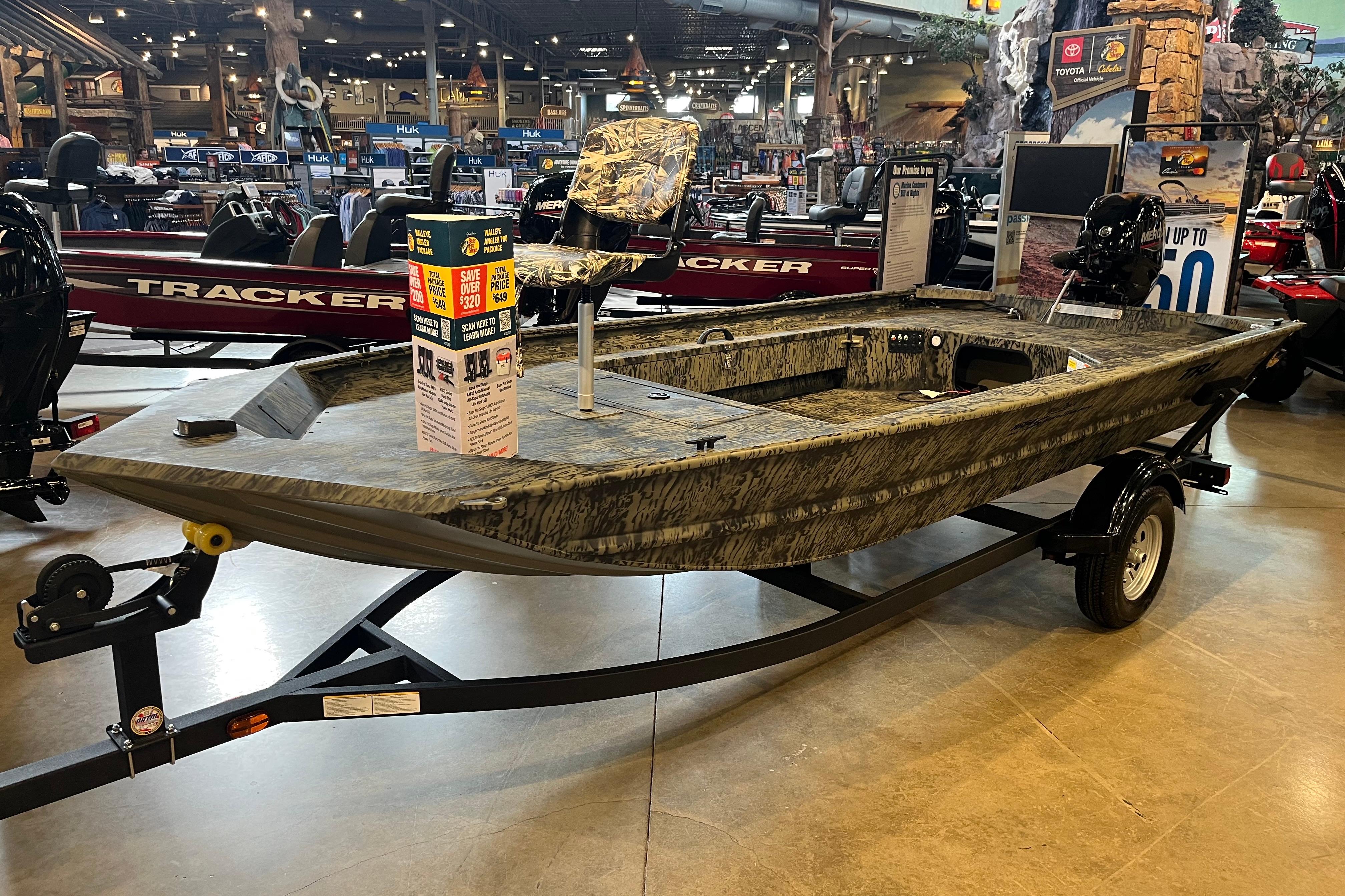 2026 Tracker Grizzly 1654 T Sportsman boat displayed in showroom on trailer.