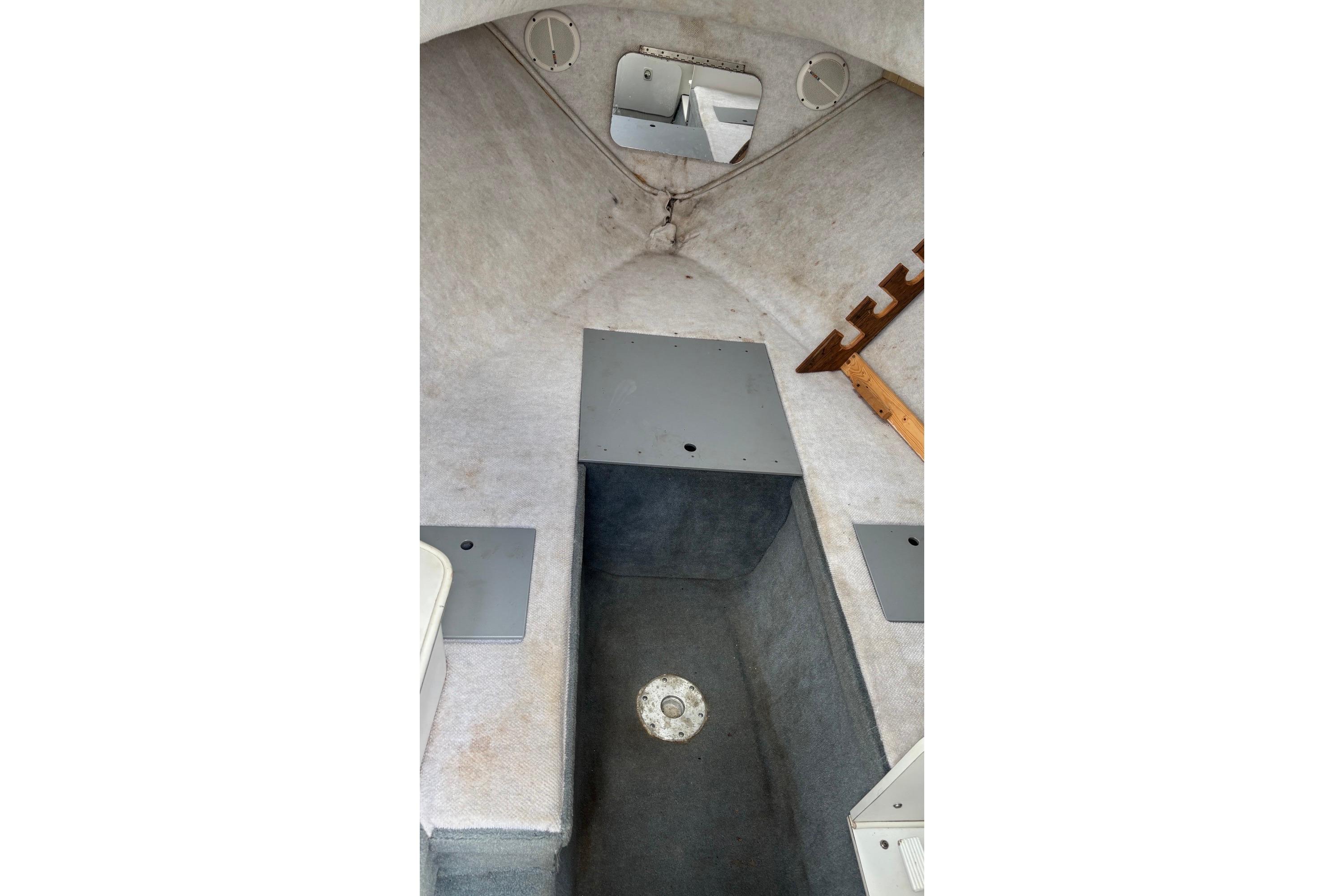 Interior cabin of 2002 Wellcraft 24 Walkaround boat, featuring storage compartments and seating.