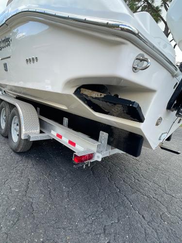 2014 Everglades 325 Center Console boat on a trailer, rear view.