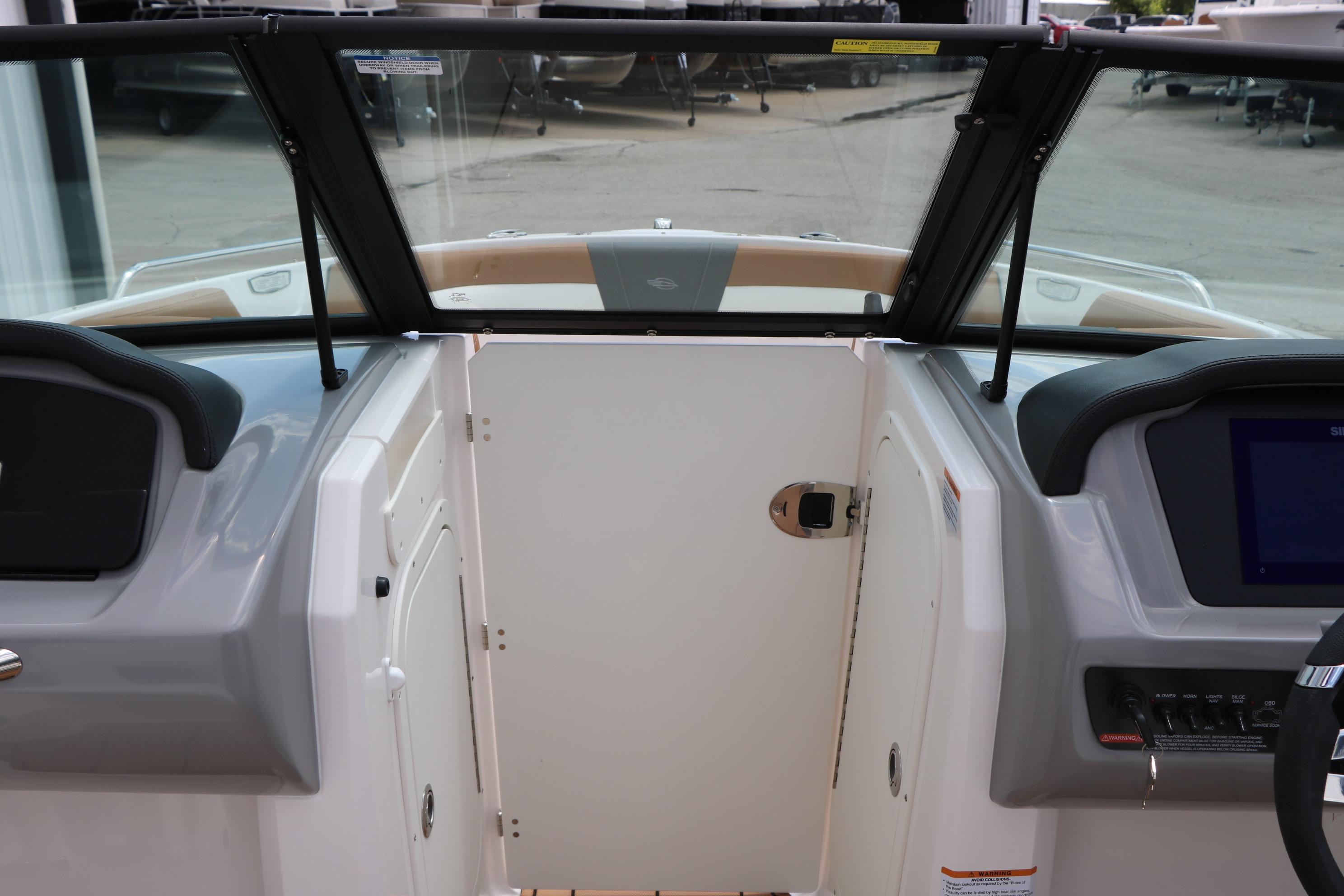 Interior view of 2025 Chaparral 23 SSi boat cockpit with windshield and control panel.