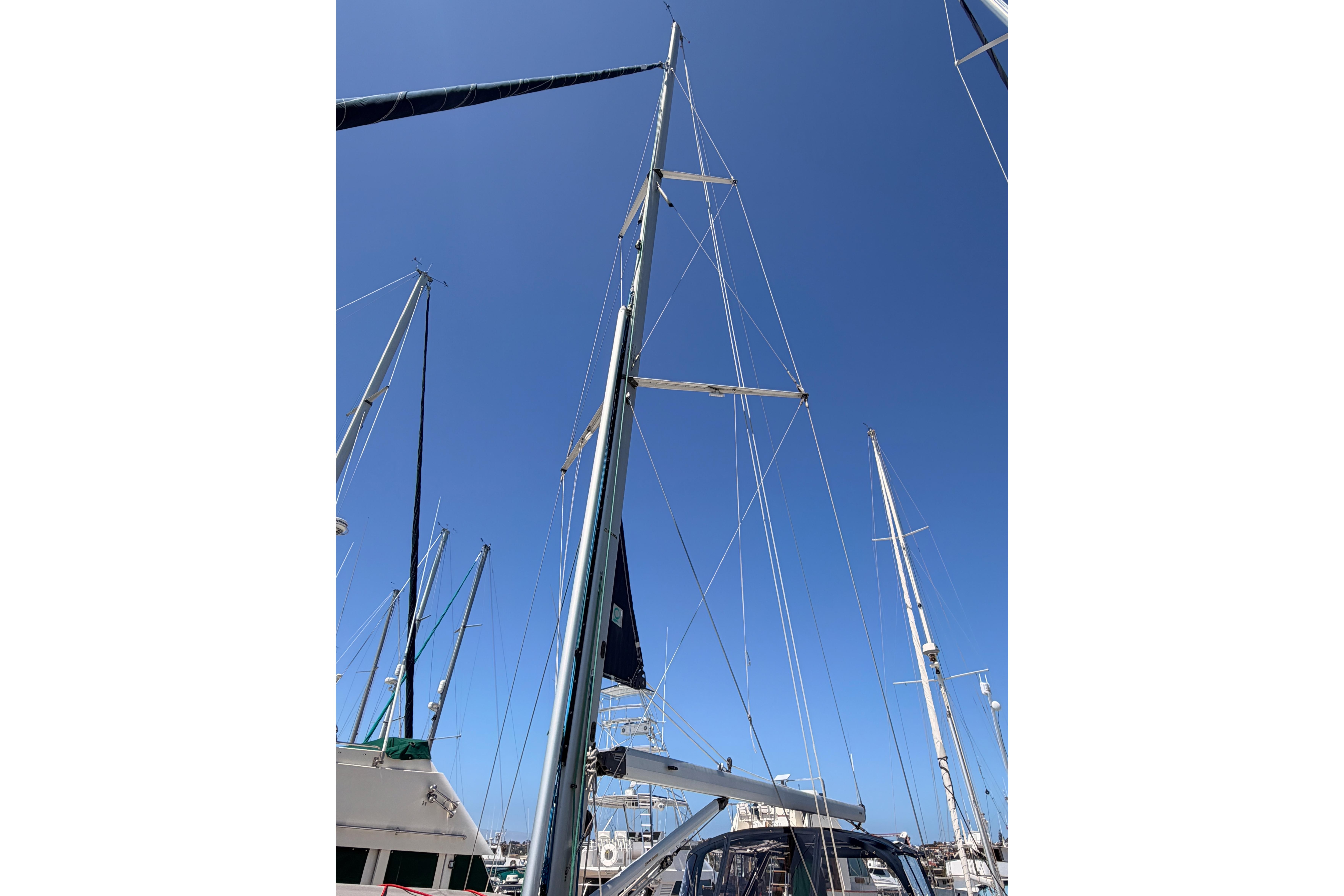 Sailboat mast of 2008 Hunter 45 Deck Salon against clear blue sky.