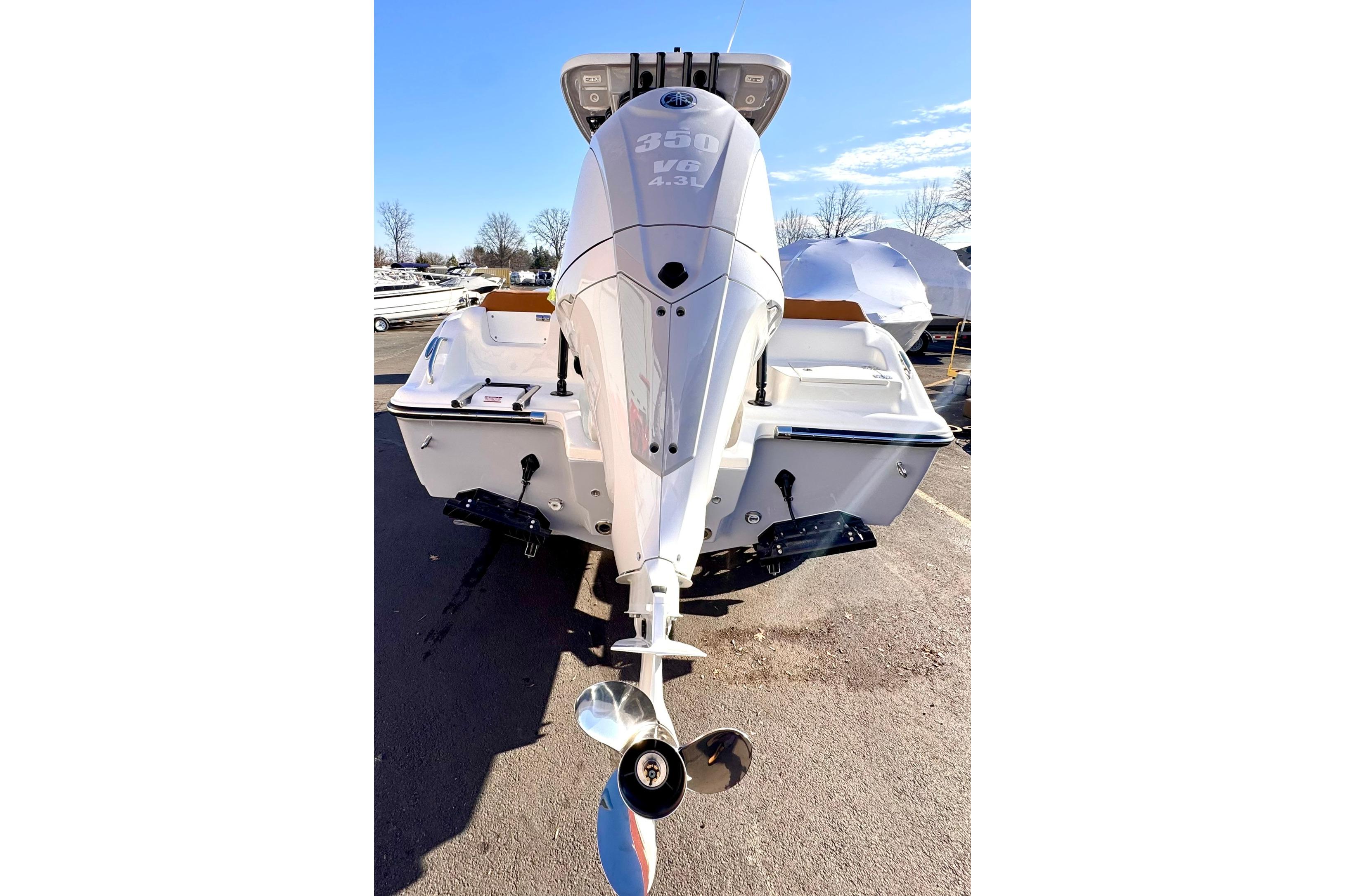 2026 Key West 239 FSR boat with powerful 350 V8 engine, parked outdoors.