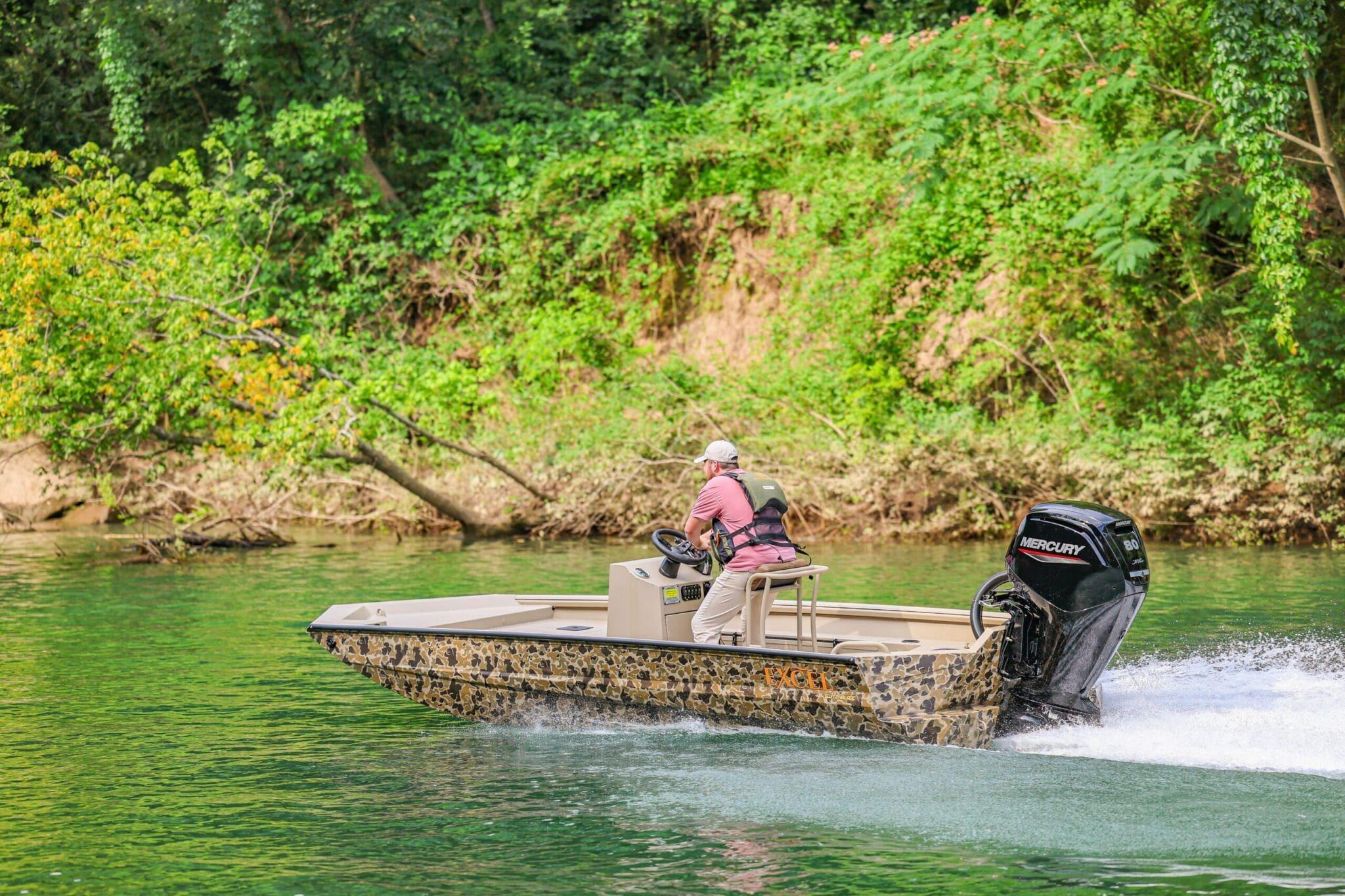 2026 Excel Switchblade boat cruising on a scenic river with lush green surroundings.