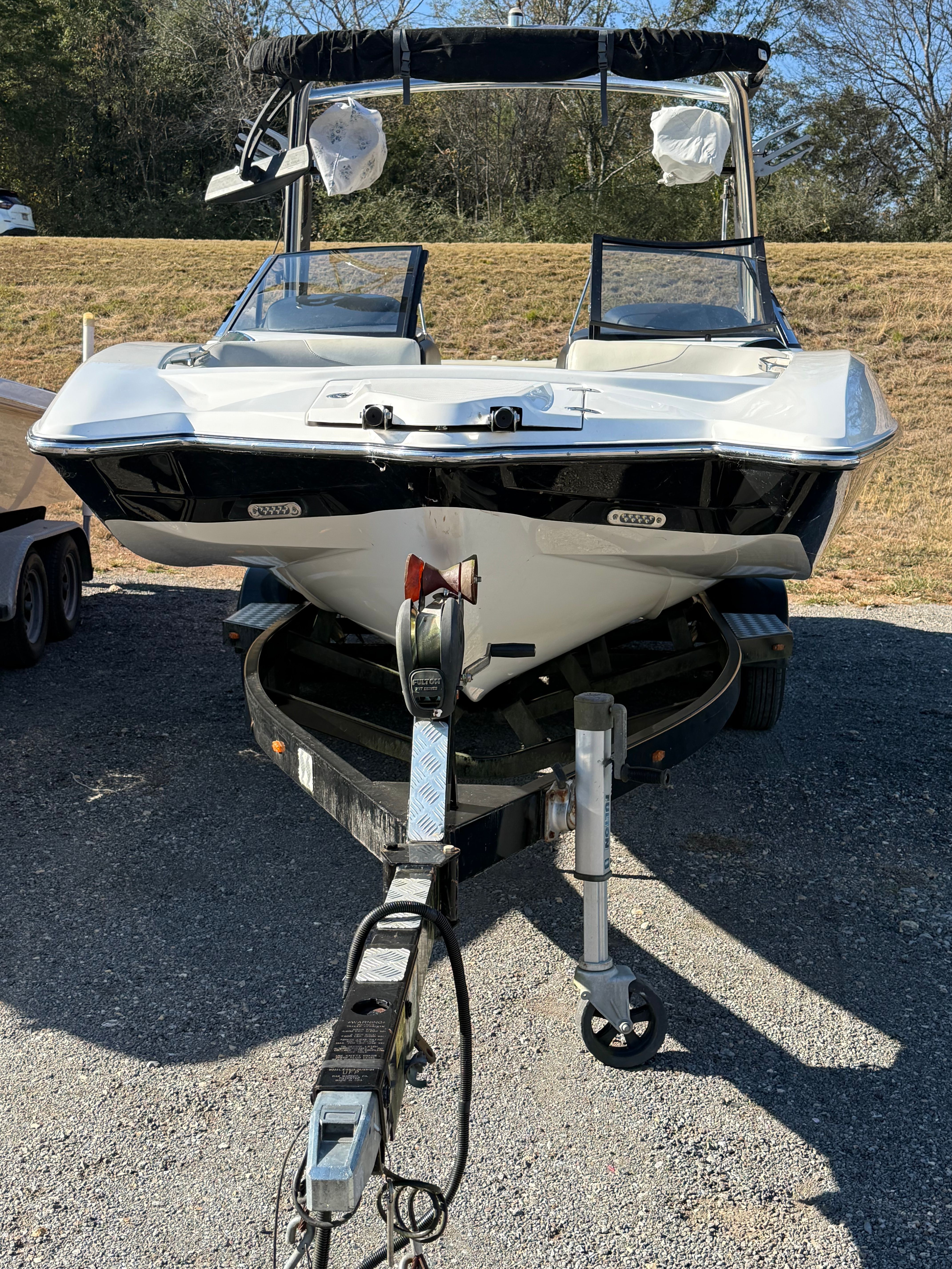 A 2013 Malibu Wakesetter 22 MXZ on a trailer, ready for transport.