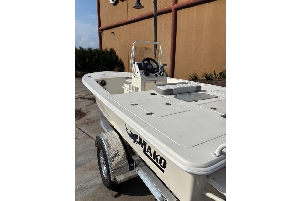 2026 Mako 18 Pro Skiff boat on trailer, parked outdoors.