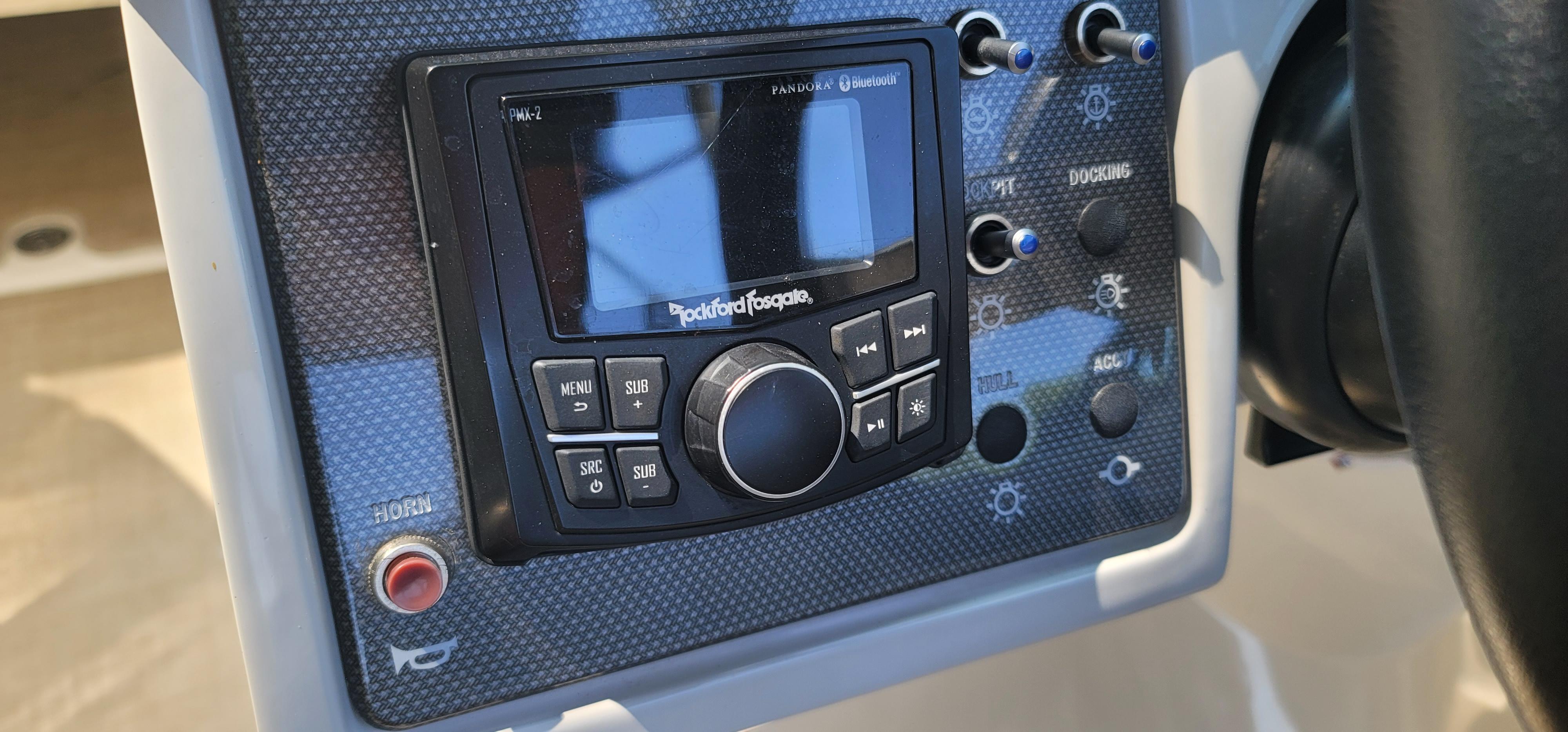 Control panel of a 2017 Sea Ray SDX 240 Outboard boat with Rockford Fosgate audio system.