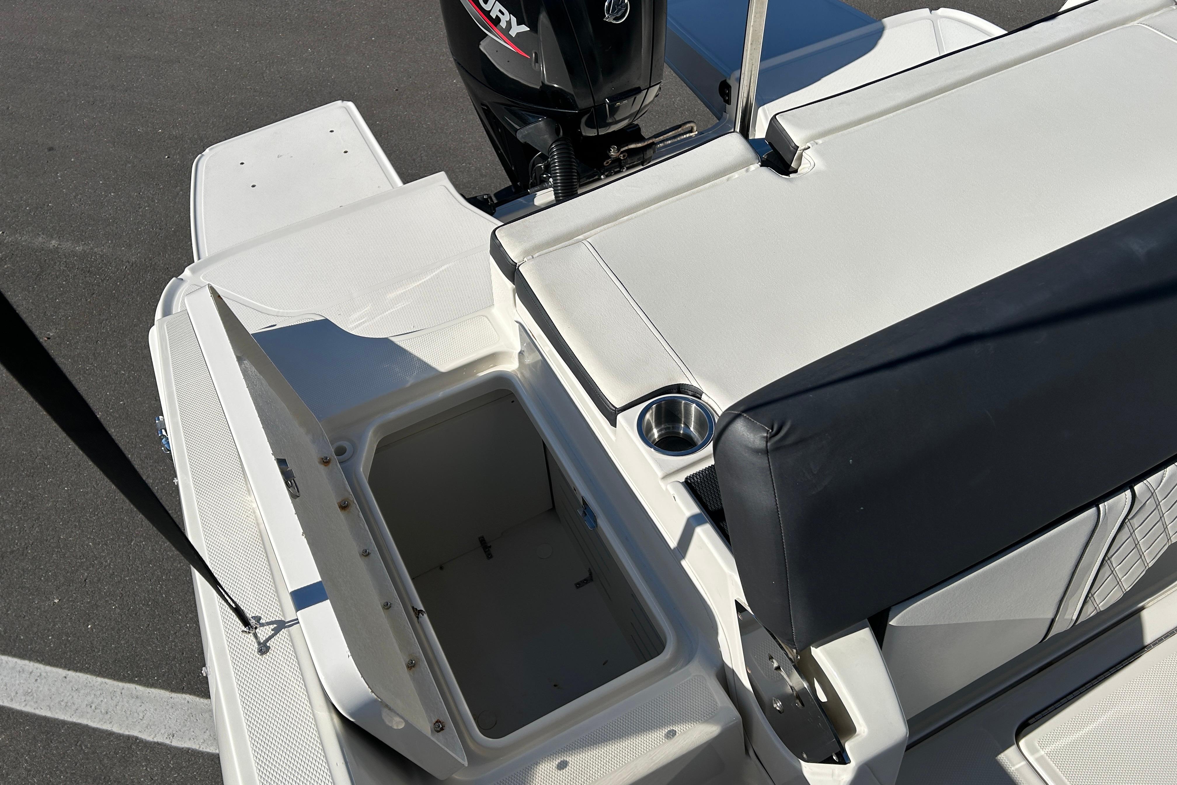 2020 Bayliner DX 2000 boat interior with open storage compartment and Mercury engine.