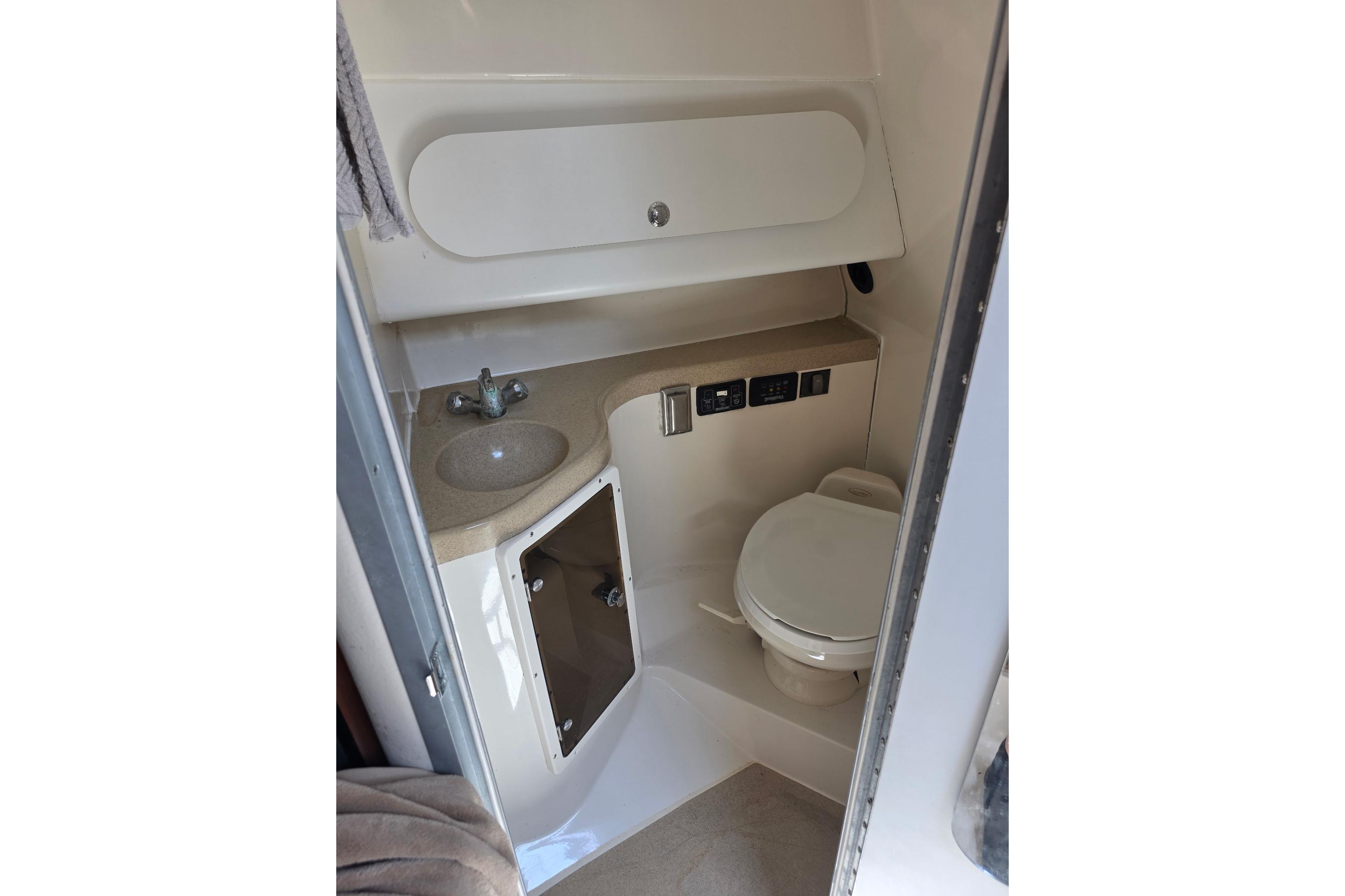 2007 Seaswirl Striper 2901 Walkaround O/B boat bathroom with sink and toilet.