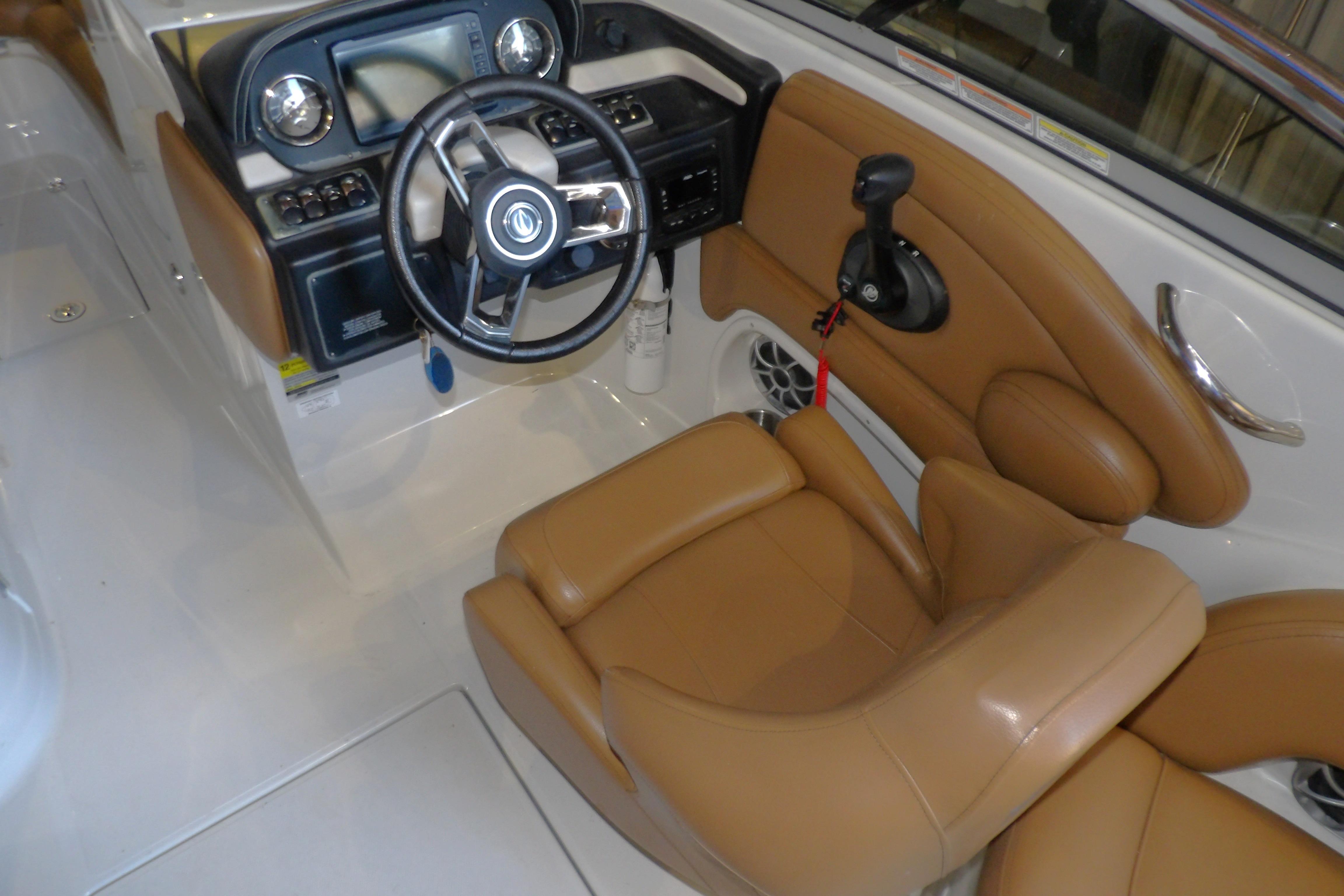 2023 Crownline 250 XSS boat interior with tan leather seating and modern dashboard.