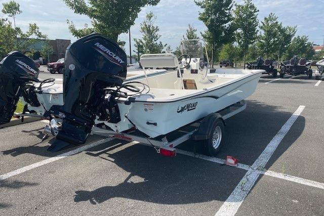2026 Mako Pro Skiff 17 CC boat on trailer in parking lot.