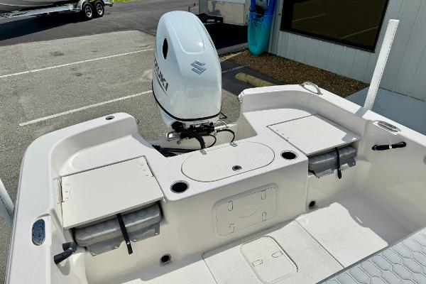 2025 Carolina Skiff 21 LS boat with Suzuki outboard motor, featuring spacious deck and storage compartments.