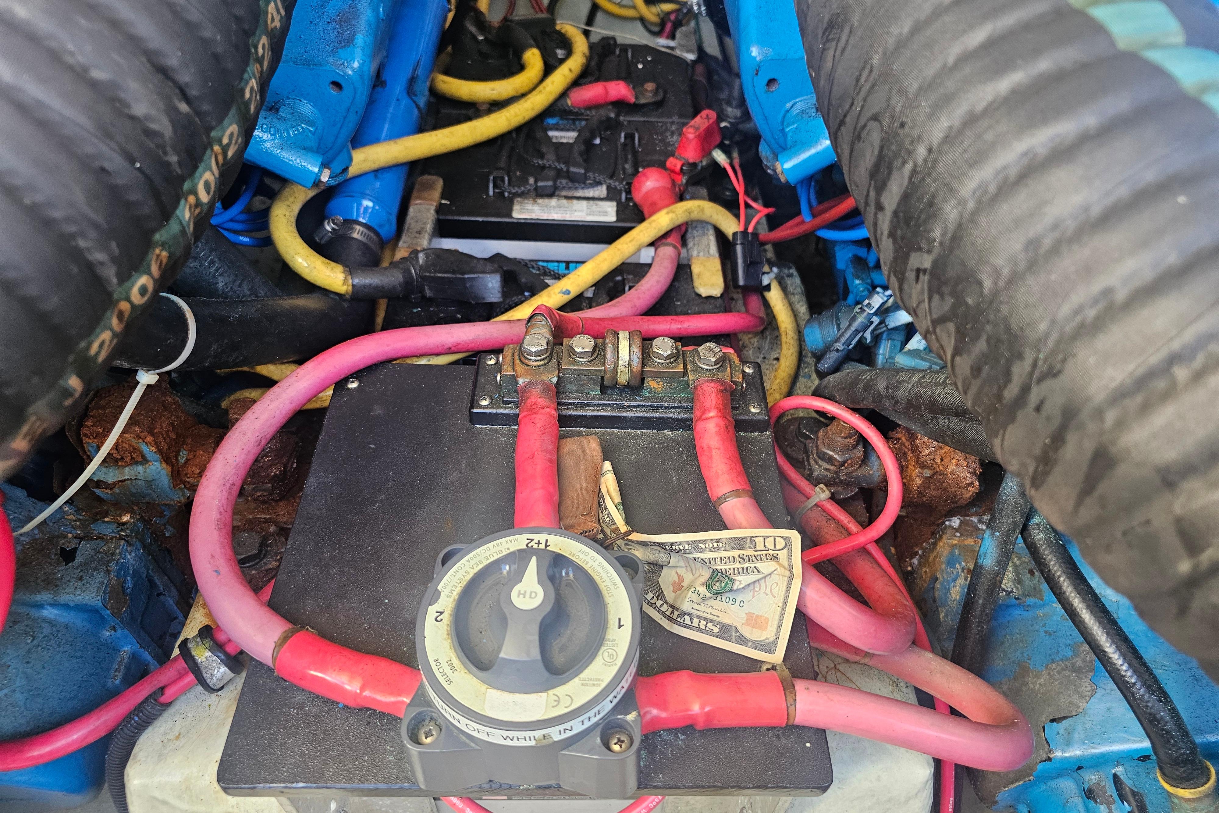 Engine compartment of a 2001 Pursuit 3000 Express with visible wiring and components.